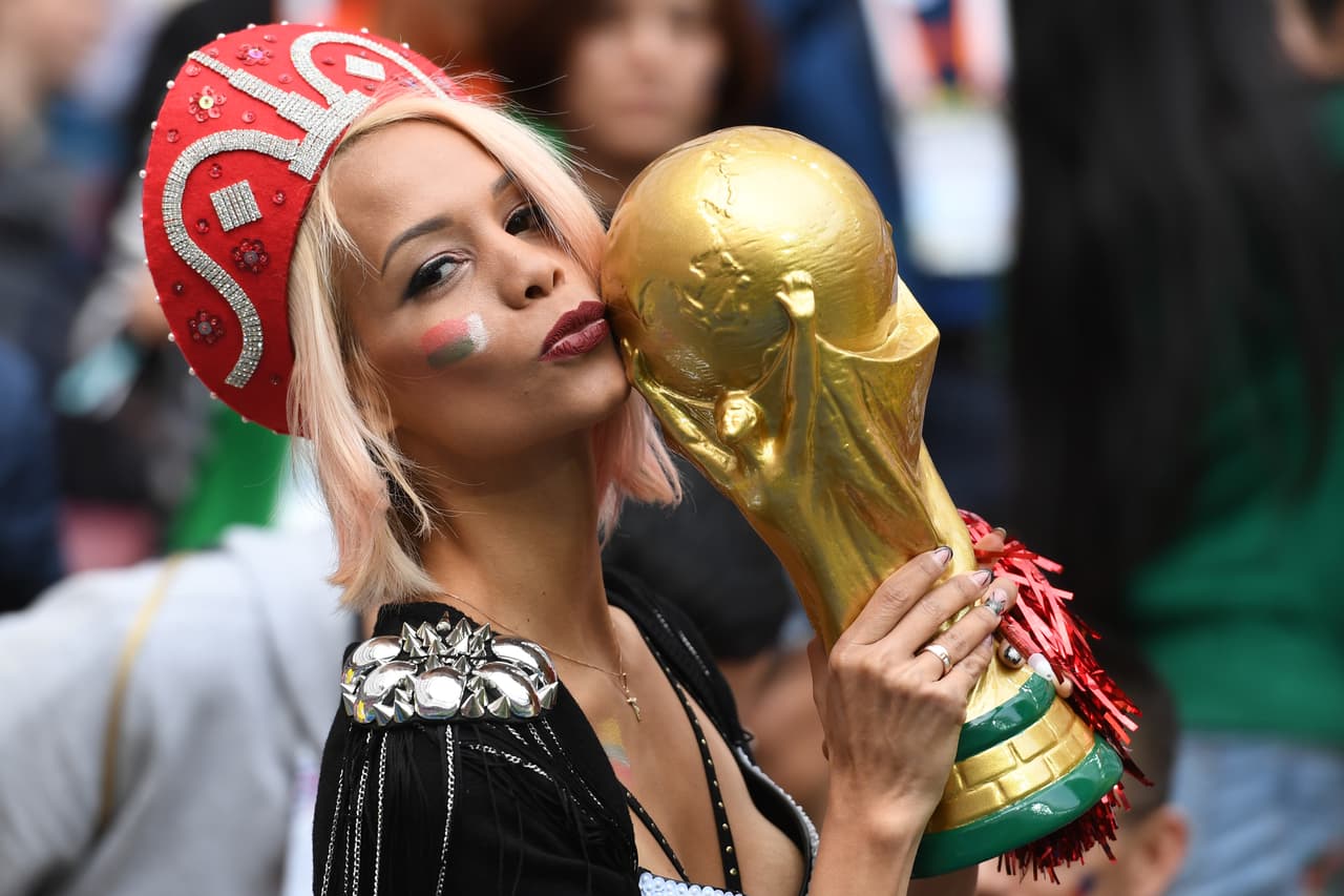 TOPSHOT - A Russian fan kisses a replica of the FIFA 2018 World Cup trophy before the Russia 2018 World Cup Group A football match between Russia and Saudi Arabia at the Luzhniki Stadium in Moscow on June 14, 2018. (Photo by Kirill KUDRYAVTSEV / AFP) / RESTRICTED TO EDITORIAL USE - NO MOBILE PUSH ALERTS/DOWNLOADS (Photo credit should read KIRILL KUDRYAVTSEV/AFP/Getty Images)