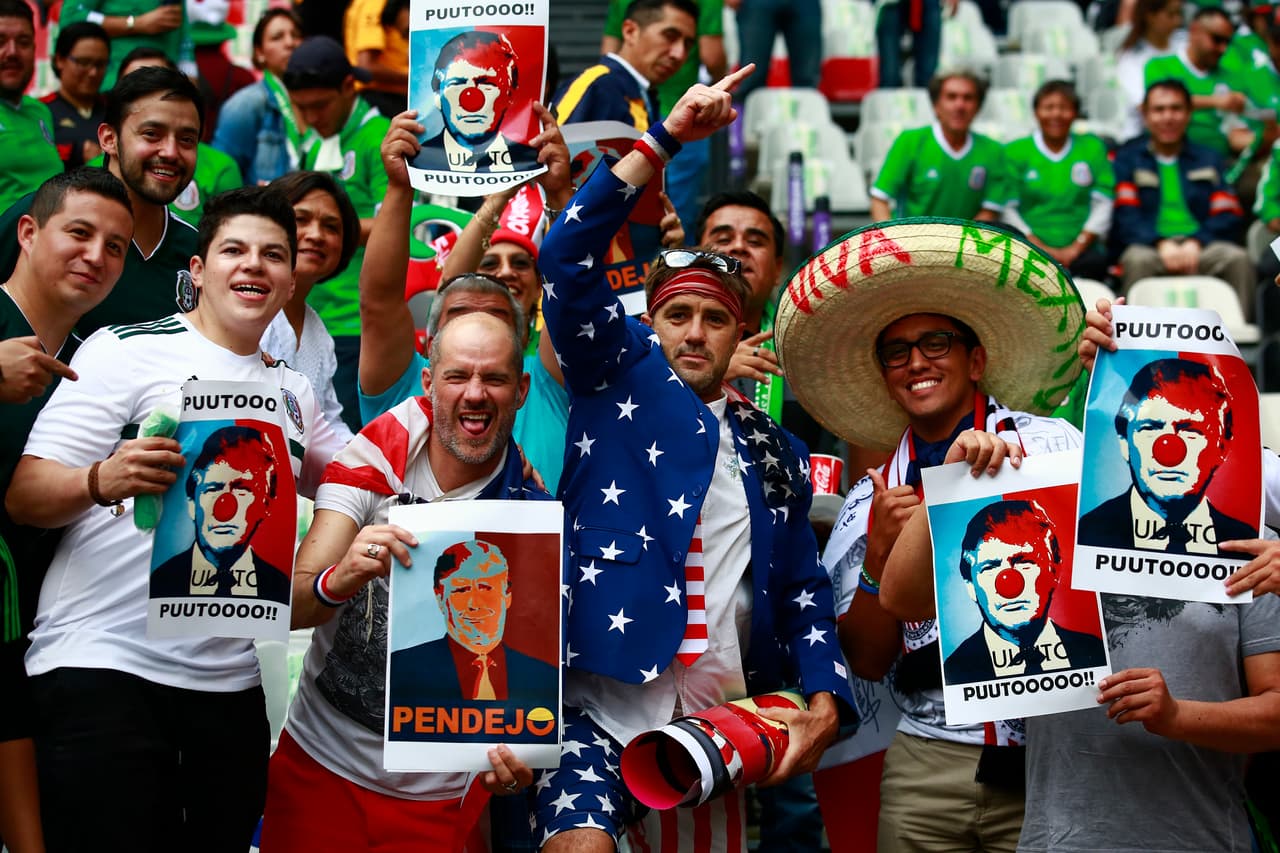 MEXICO CITY, MEXICO - JUNE 11: US and Mexican fans show banners with the image of US President Donal Trump prior to the match between Mexico and The United States as part of the FIFA 2018 World Cup Qualifiers at Azteca Stadium on June 11, 2017 in Mexico City, Mexico. (Photo by Miguel Tovar/LatinContent/Getty Images)