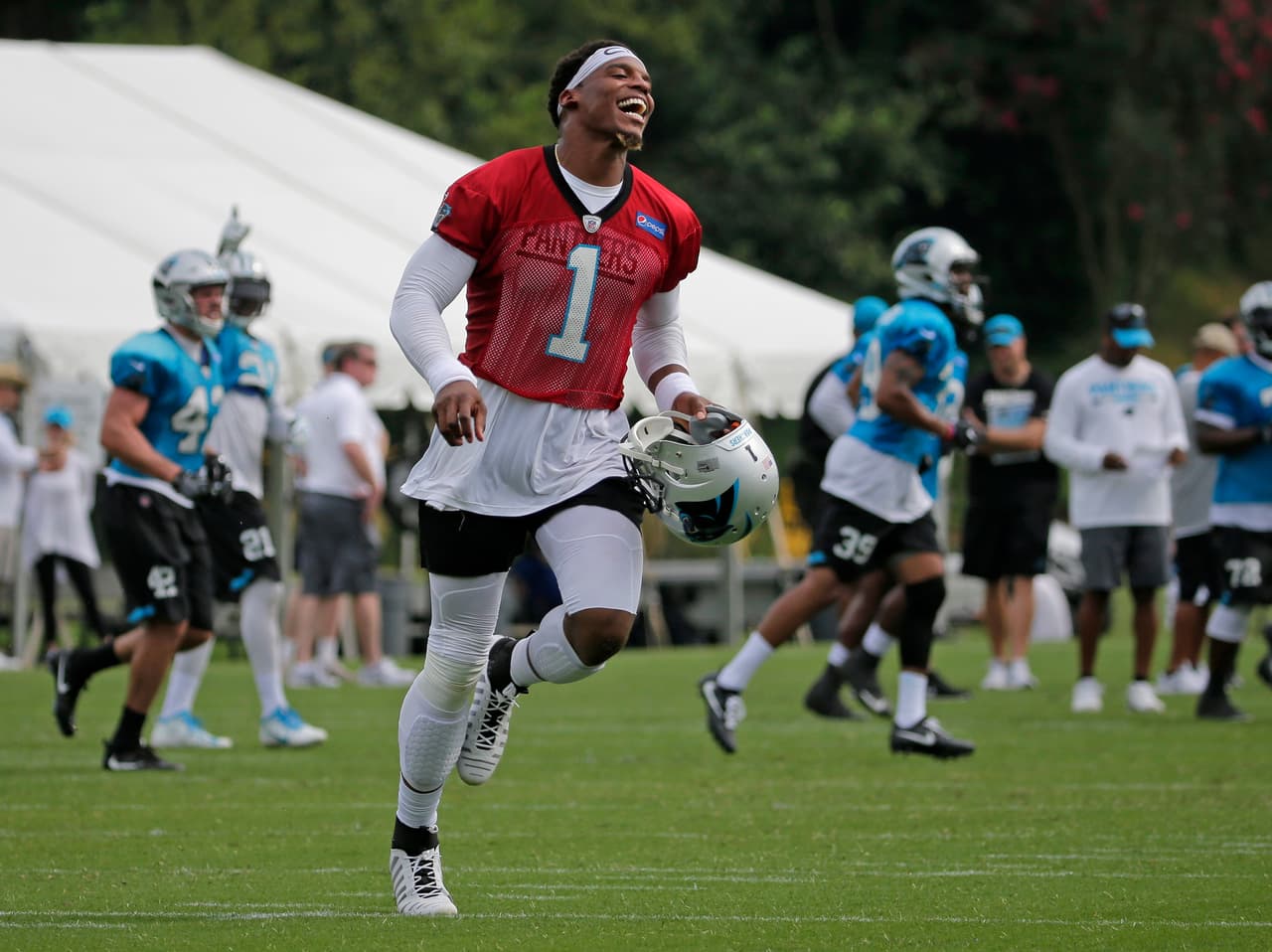 Carolina Panthers' Cam Newton (1) reacts after his touchdown pass during practice at the NFL team's football training camp at Wofford College in Spartanburg, S.C., Thursday, July 27, 2017. (AP Photo/Chuck Burton)