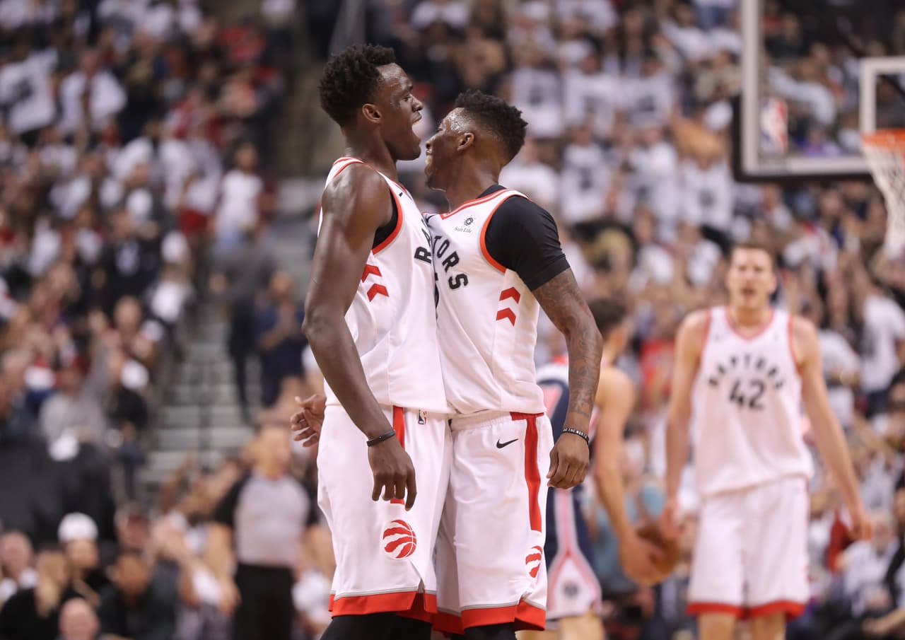 TORONTO, ON - APRIL 14: Delon Wright #55 of the Toronto Raptors celebrates his three-pointer with Pascal Siakam #43 against the Washington Wizards in the second quarter during Game One of the first round of the 2018 NBA Playoffs at Air Canada Centre on April 14, 2018 in Toronto, Canada. NOTE TO USER: User expressly acknowledges and agrees that, by downloading and or using this photograph, User is consenting to the terms and conditions of the Getty Images License Agreement. (Photo by Tom Szczerbowski/Getty Images)