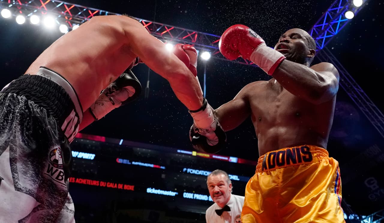 QUEBEC CITY, QC - DECEMBER 1: Oleksandr Gvosdyk (black trunk) punches Adonis Stevenson (gold trunk) during their WBC light heavyweight championship fight at the Videotron Center on December 1, 2018 in Quebec City, Quebec, Canada. (Photo by Mathieu Belanger/Getty Images)