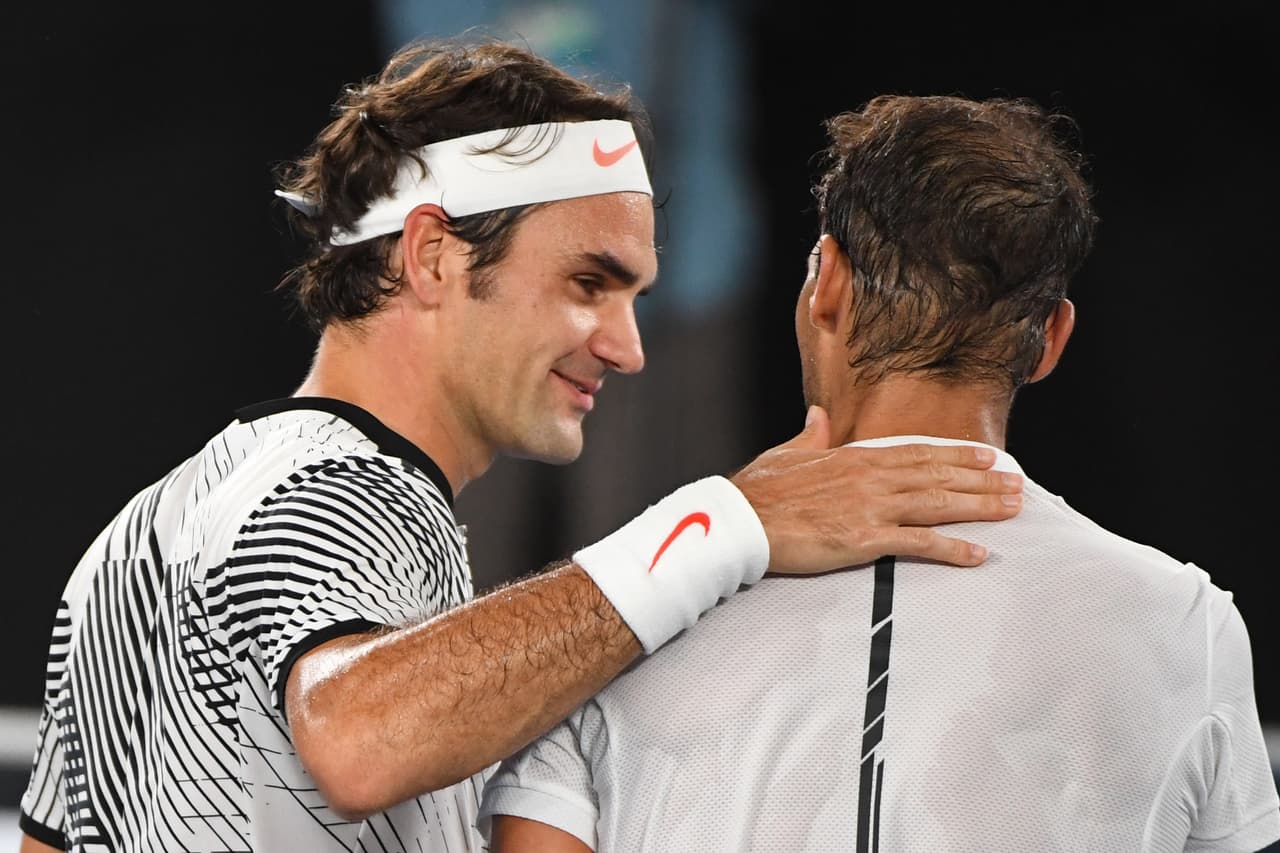 Switzerland's Roger Federer (L) speaks with Spain's Rafael Nadal after winning the men's singles final on day 14 of the Australian Open tennis tournament in Melbourne on January 29, 2017. / AFP / WILLIAM WEST / IMAGE RESTRICTED TO EDITORIAL USE - STRICTLY NO COMMERCIAL USE (Photo credit should read WILLIAM WEST/AFP/Getty Images)