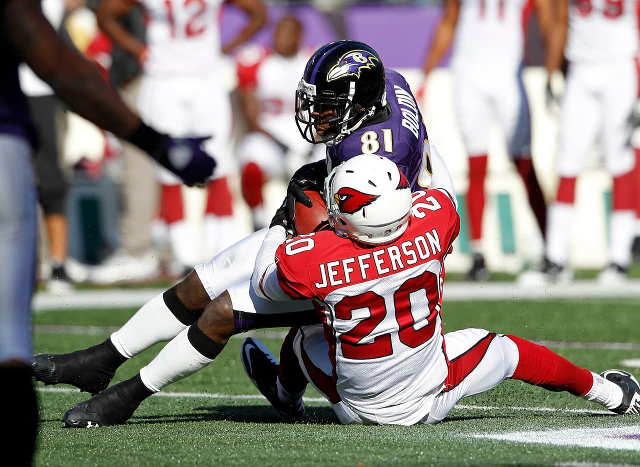 Arizona Cardinals cornerback A.J. Jefferson (20) tackles Baltimore Ravens wide receiver Anquan Boldin (81) after Bolding catches a pass during the NFL week 8 football game against the Baltimore Ravens on Sunday, October 30, 2011 in Baltimore, Maryland. The Ravens came back in the second half to win the game 30-27. (AP Photo/Paul Spinelli)