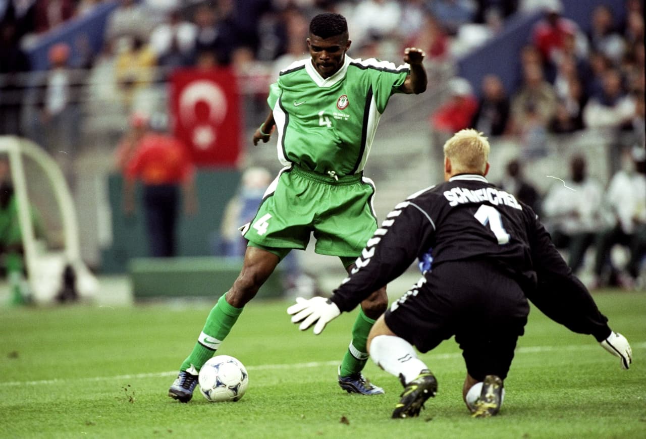 28 Jun 1998: Nwankwo Kanu of Nigeria tries to go past Peter Schmeichel of Denmark during the World Cup second round match at the Stade de France in St Denis, France. Denmark won 4-1. \ Mandatory Credit: Clive Brunskill /Allsport