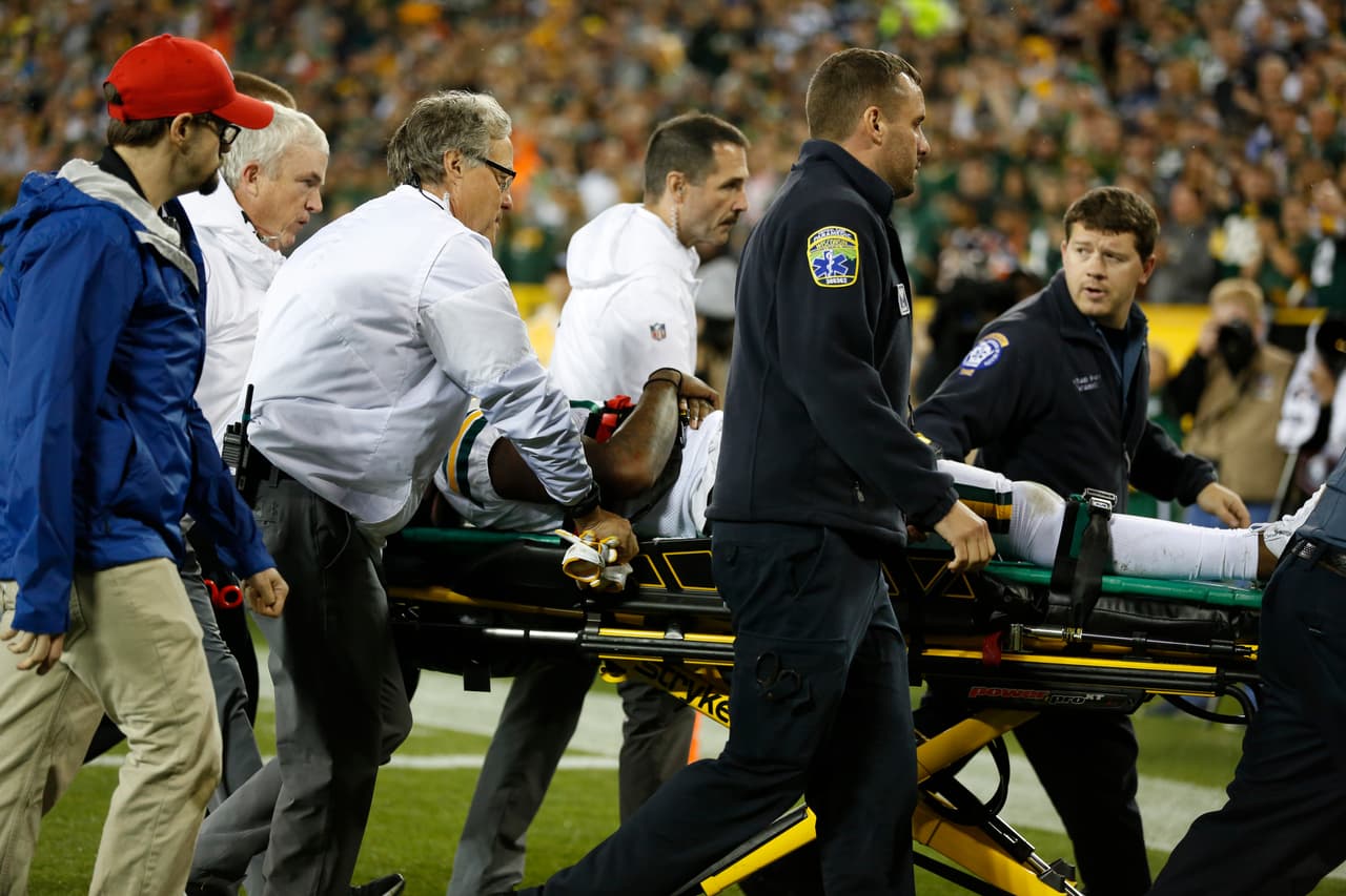Green Bay Packers' Davante Adams is taken off the field after being hit in the head during the second half of an NFL football game against the Chicago Bears Thursday, Sept. 28, 2017, in Green Bay, Wis. (AP Photo/Matt Ludtke)