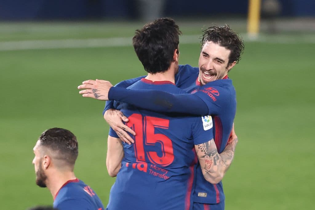 Atletico Madrid's Montenegrin defender Stefan Savic (C) celebrates with Atletico Madrid's Croatian defender Sime Vrsaljko after scoring during the Spanish league football match between Villarreal CF and Club Atletico de Madrid at La Ceramica stadium in Vila-real on February 28, 2021. (Photo by JOSE JORDAN / AFP) (Photo by JOSE JORDAN/AFP via Getty Images)
