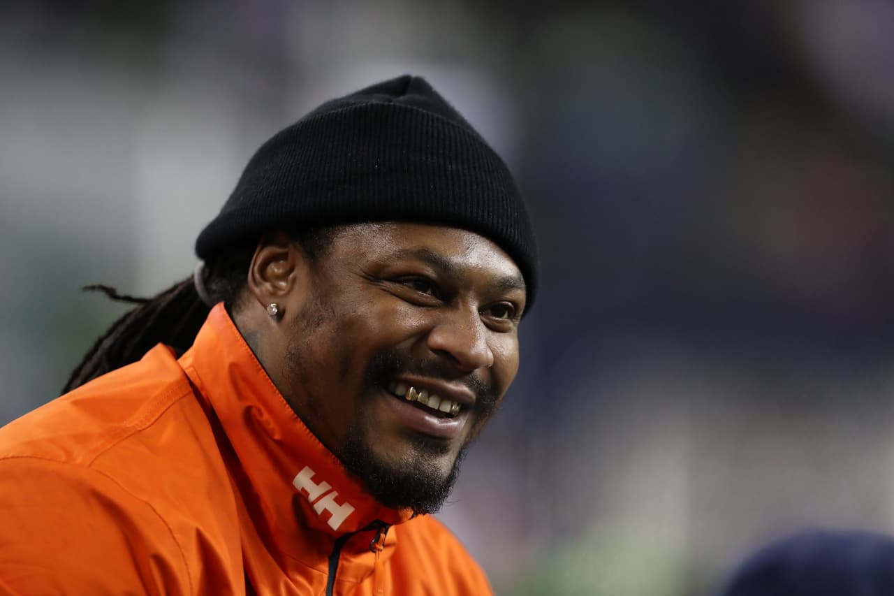 Ex Seattle Seahawks player Marshawn Lynch speaks with teammates on the bbench during an NFL game between the Seattle Seahawks and Carolina Panthers , Sunday, Dec 4, 2016, in Seattle. (Tom Hauck via AP)