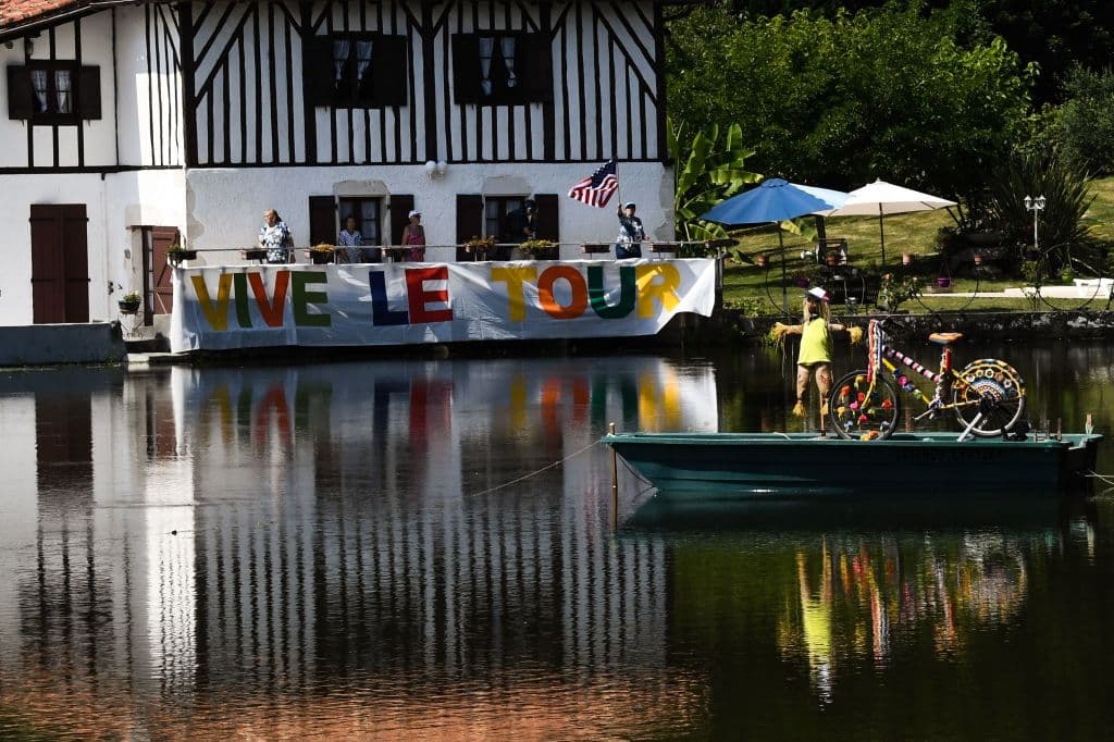 Spectators cheer from their decorated house on the side of the route during the 18th stage of the 105th edition of the Tour de France cycling race, on July 26, 2018 between Trie-sur-Baise and Pau, southwestern France. (Photo by Jeff PACHOUD / AFP) (Photo credit should read JEFF PACHOUD/AFP/Getty Images)