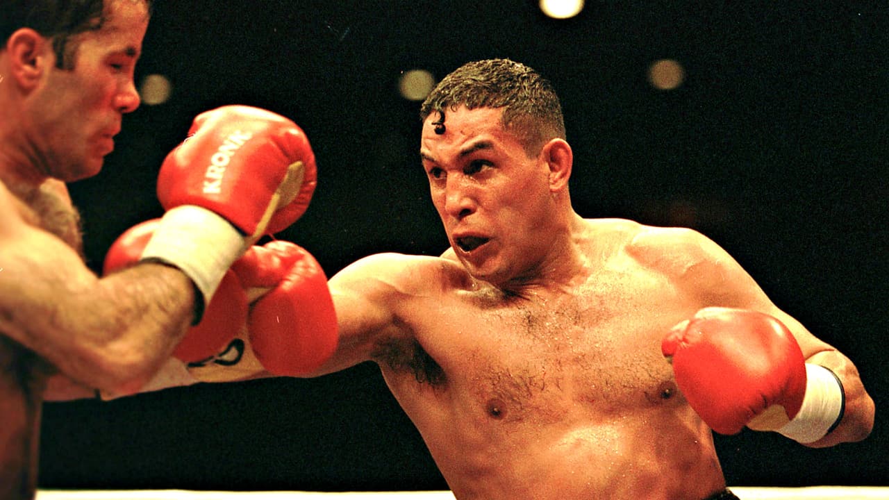 Héctor ‘El Macho’ Camacho nació en San Juan, Puerto Rico, en 1962, pero construyó gran parte de su vida en Nueva York, ciudad a la que emigró con su madre. Fue Campeón Mundial de superpluma, peso ligero y junior welter. ‘El Macho’ Camacho fue agredido con arma de fuego en el 2012, aguantó algunas horas más conectado a un respirador y en estado de coma. ‘El Macho’ peleó contra tres infartos masivos, pero el tercero lo derribó por completo. Fue un excelso boxeador que, sin embargo, pasó por problemas de consumo de drogas, estuvo preso y perdió dinero en lujos y demandas.