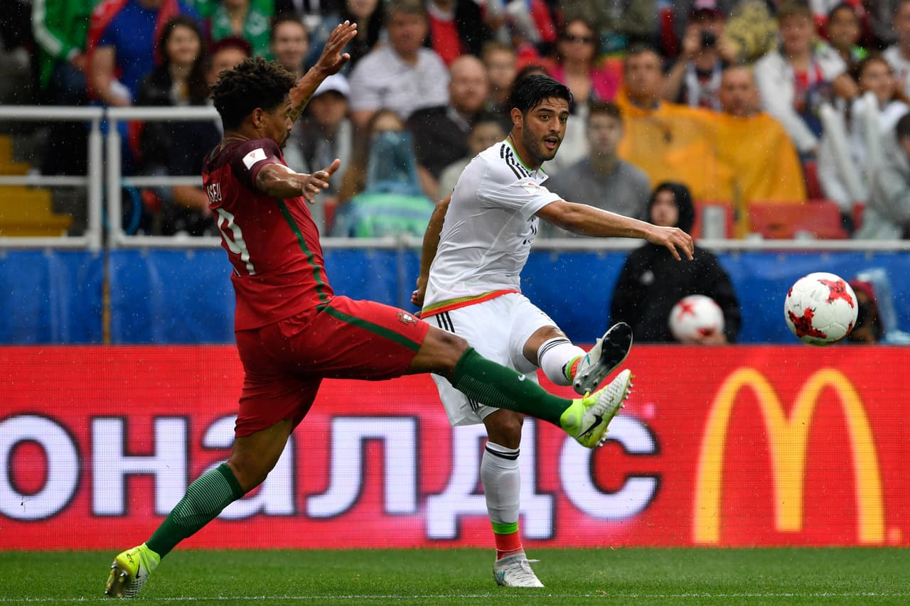 Mexico's midfielder Carlos Vela (R) shoots the ball in front of Portugal's defender Eliseu during the 2017 Confederations Cup third place football match between Portugal and Mexico at Spartak Stadium in Moscow on July 2, 2017. / AFP PHOTO / Alexander NEMENOV (Photo credit should read ALEXANDER NEMENOV/AFP/Getty Images)