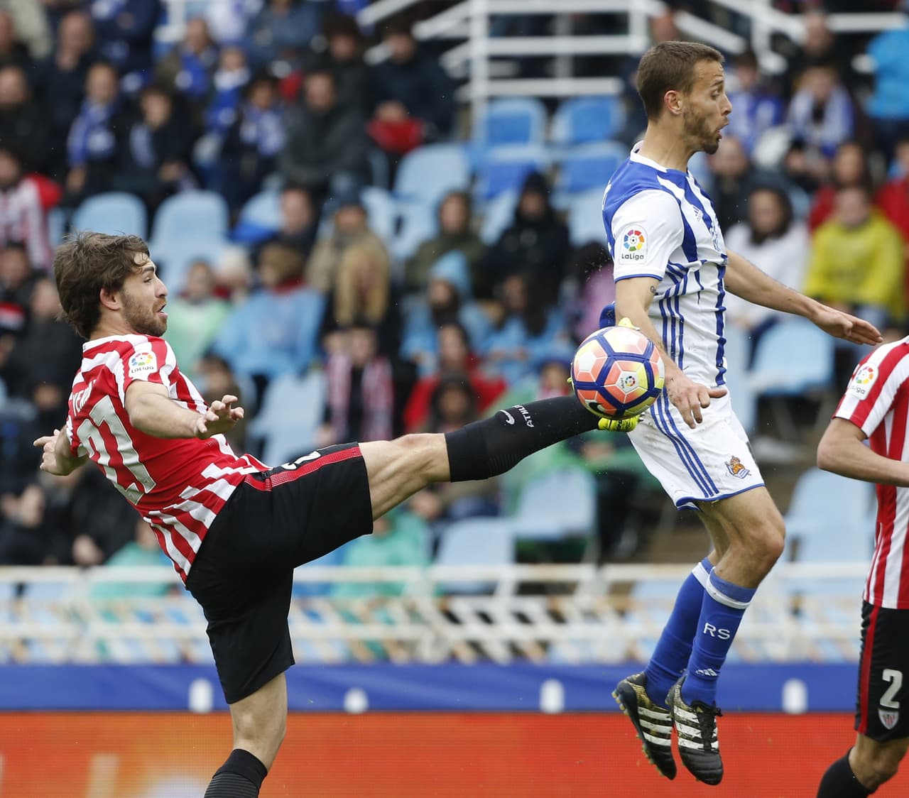 Sergio Canales (Real Sociedad) recibe un golpe de su marcador, Yeray Álvarez (Bilbao) en el medio campo.