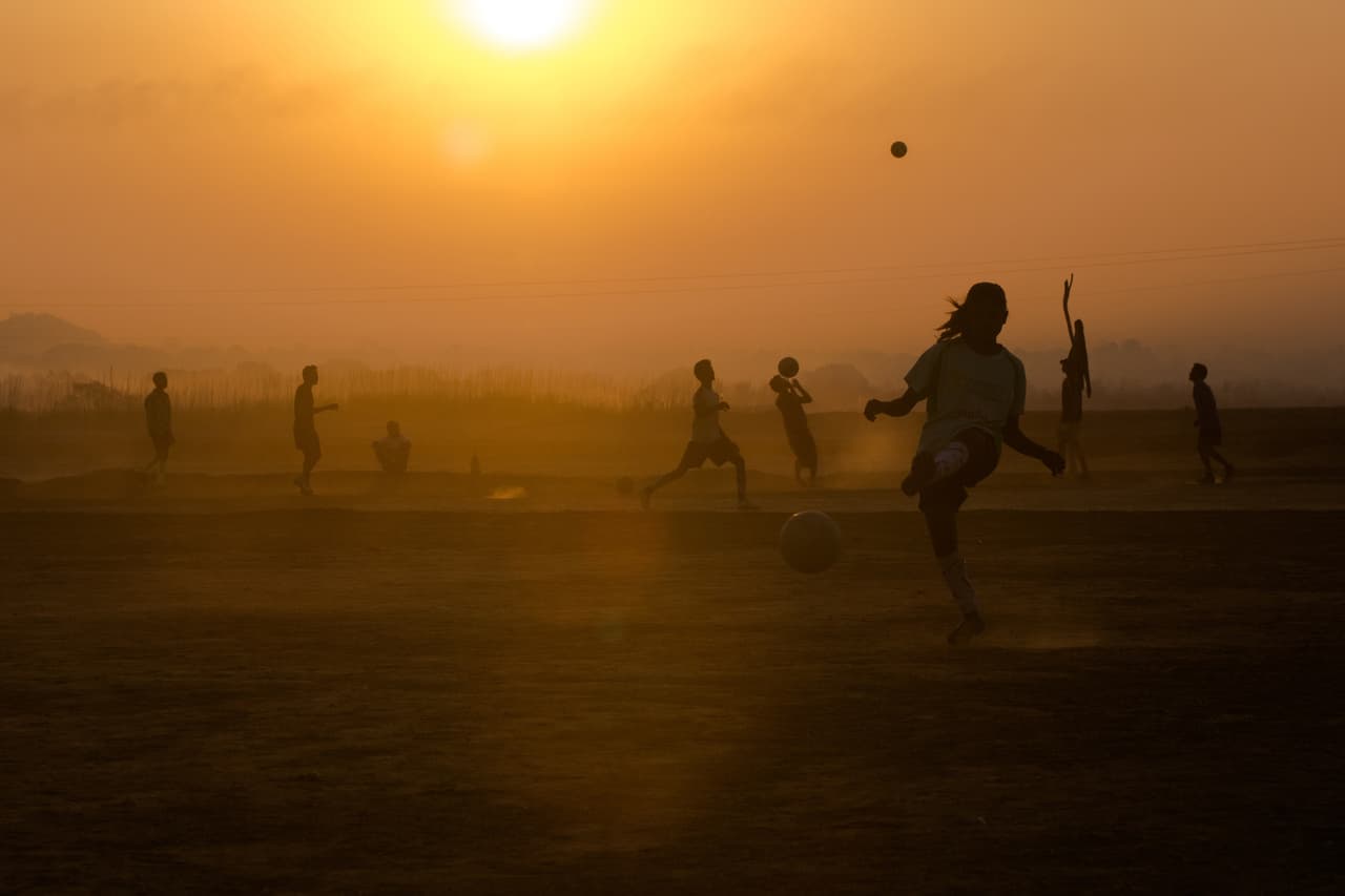 An Indian female student from 'The Talented Girls' and 'The Superstars' Yuwa School football training teams kicks a ball during a practice session at a football training ground in Hesatu Village, some 16 kilometres from Ranchi on March 23, 2015. The Yuwa NGO runs a school and football programme in the eastern Indian state of Jharkhand offering education and football coaching to girls from villages where they would be traditionally expected to give up their education and get married at around the age of 15 or 16. Divided into teams whose names they chose themselves, the girls attend class and training sessions in the mornings and afternoons as part of a programme that offers support, friendship and education to empower students to shape their own futures. AFP PHOTO / Rebecca CONWAY (Photo credit should read Rebecca Conway/AFP/Getty Images)