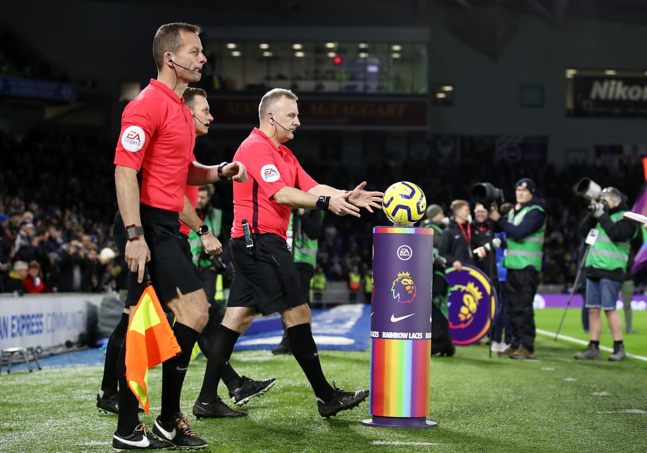 BRIGHTON, ENGLAND - DECEMBER 08: Match Referee Jonathan Moss collects the match ball from a Stonewall Rainbow Laces branded plinth as he walks out prior to the Premier League match between Brighton & Hove Albion and Wolverhampton Wanderers at American Express Community Stadium on December 08, 2019 in Brighton, United Kingdom. (Photo by Bryn Lennon/Getty Images)