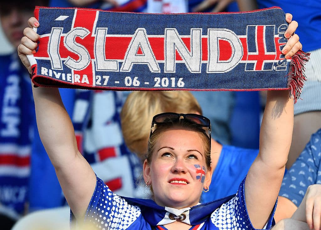 An Iceland supporter cheeholds a scarf prior to the Euro 2016 round of 16 football match between England and Iceland at the Allianz Riviera stadium in Nice on June 27, 2016. / AFP / BERTRAND LANGLOIS (Photo credit should read BERTRAND LANGLOIS/AFP/Getty Images)