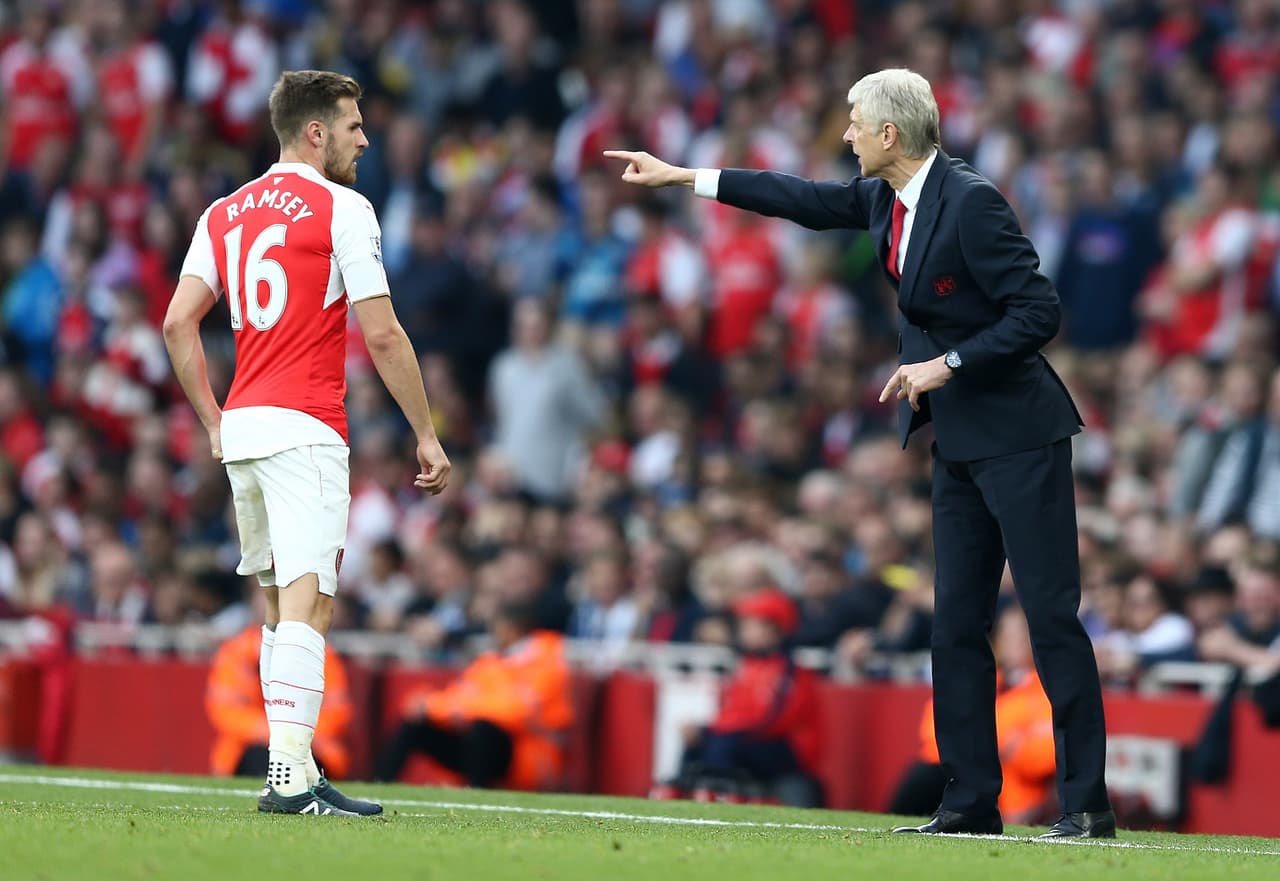 Wenger le da indicaciones a Ramsey en un juego del Arsenal