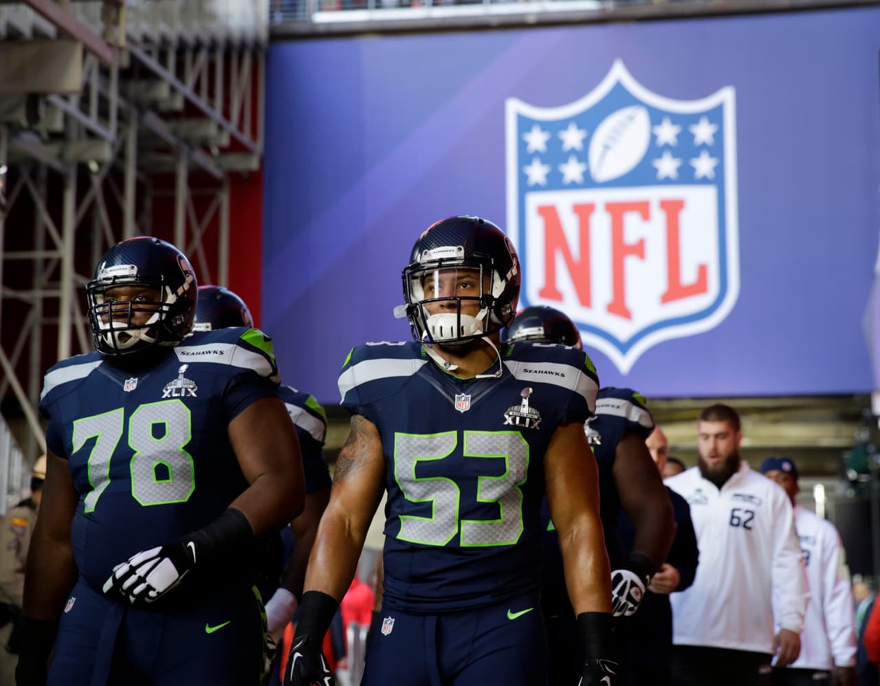 Seattle Seahawks outside linebacker Malcolm Smith (53) and Alvin Bailey (78) make their way to the field before the NFL Super Bowl XLIX football game against the New England Patriots Sunday, Feb. 1, 2015, in Glendale, Ariz. (AP Photo/David Goldman)
