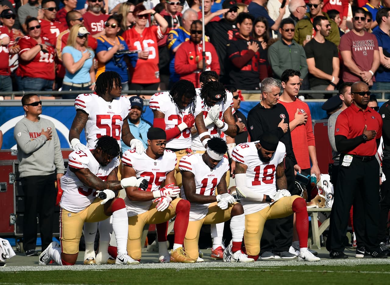 LOS ANGELES, CA - DECEMBER 31: Several members of the San Francisco 49ers kneel during the anthem prior to the football game against Los Angeles Rams at Los Angeles Memorial Coliseum on December 31, 2017 in Los Angeles, California. (Photo by Kevork Djansezian/Getty Images)