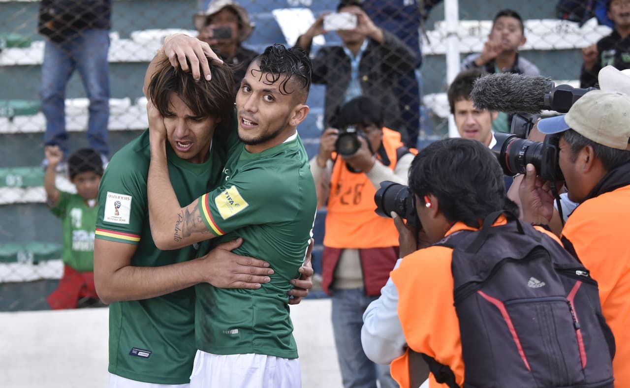 Bolivia's Marcelo Martins (L) celebrates with teammate Yasmani Duk after an own goal by Paraguay's Gustavo Gomez during their 2018 FIFA World Cup qualifier football match in La Paz, on November 15, 2016. / AFP / AIZAR RALDES (Photo credit should read AIZAR RALDES/AFP/Getty Images)