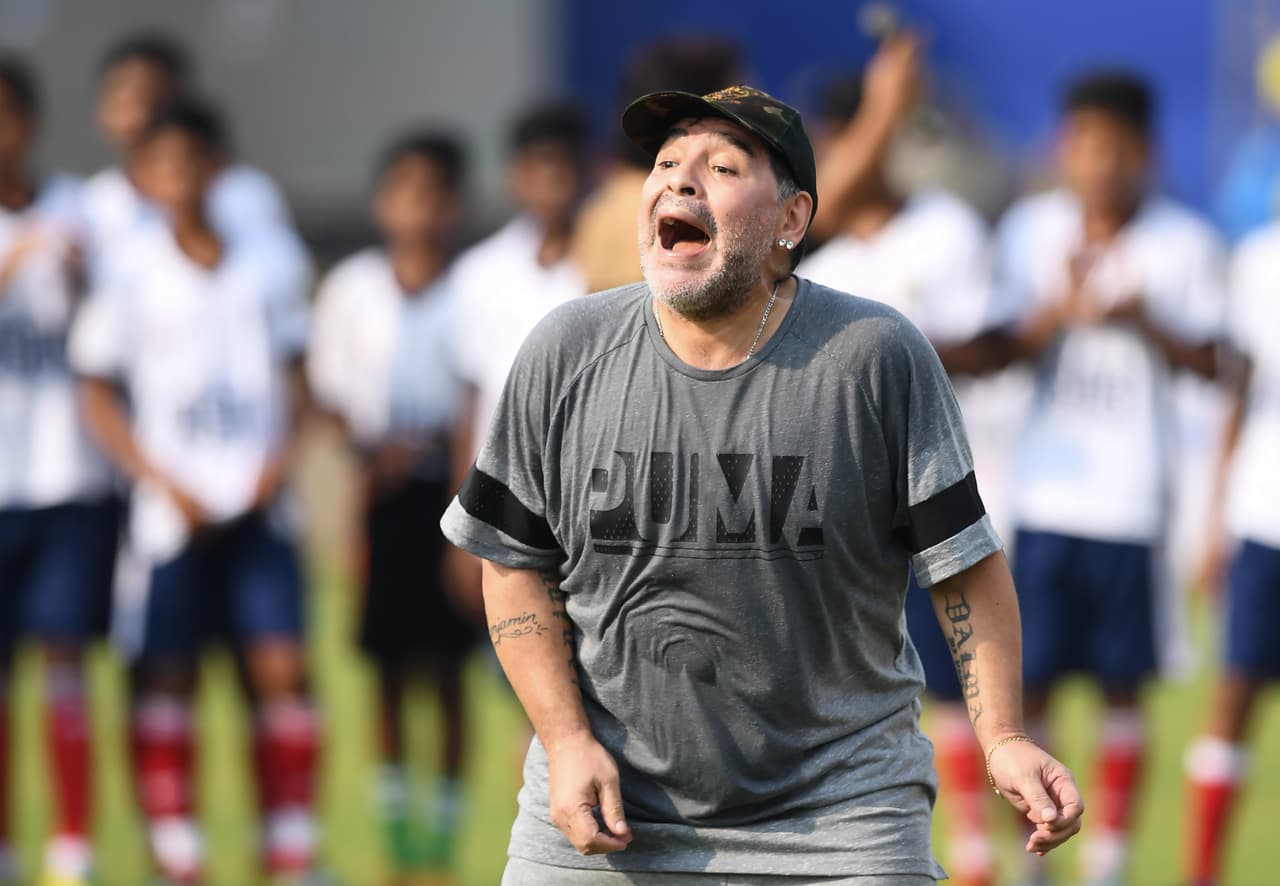 Argentine footballer Diego Maradona gestures during a football workshop with school students in Barasat, around 35 Km north of Kolkata on December 12, 2017. Maradona is on a private visit to India. / AFP PHOTO / Dibyangshu SARKAR (Photo credit should read DIBYANGSHU SARKAR/AFP/Getty Images)