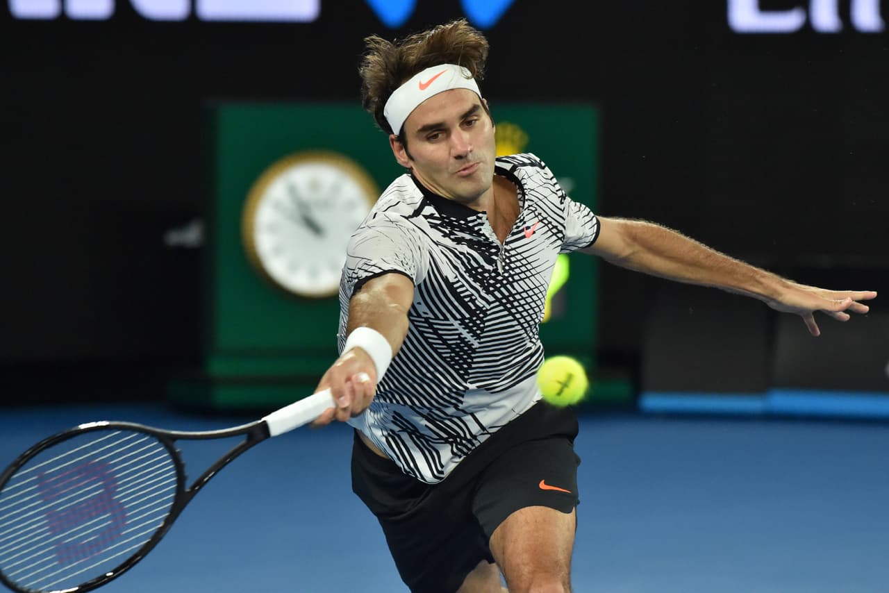 Switzerland's Roger Federer hits a return against Switzerland's Stanislas Wawrinka during their men's singles semi-final match on day 11 of the Australian Open tennis tournament in Melbourne on January 26, 2017. / AFP / PETER PARKS / IMAGE RESTRICTED TO EDITORIAL USE - STRICTLY NO COMMERCIAL USE (Photo credit should read PETER PARKS/AFP/Getty Images)