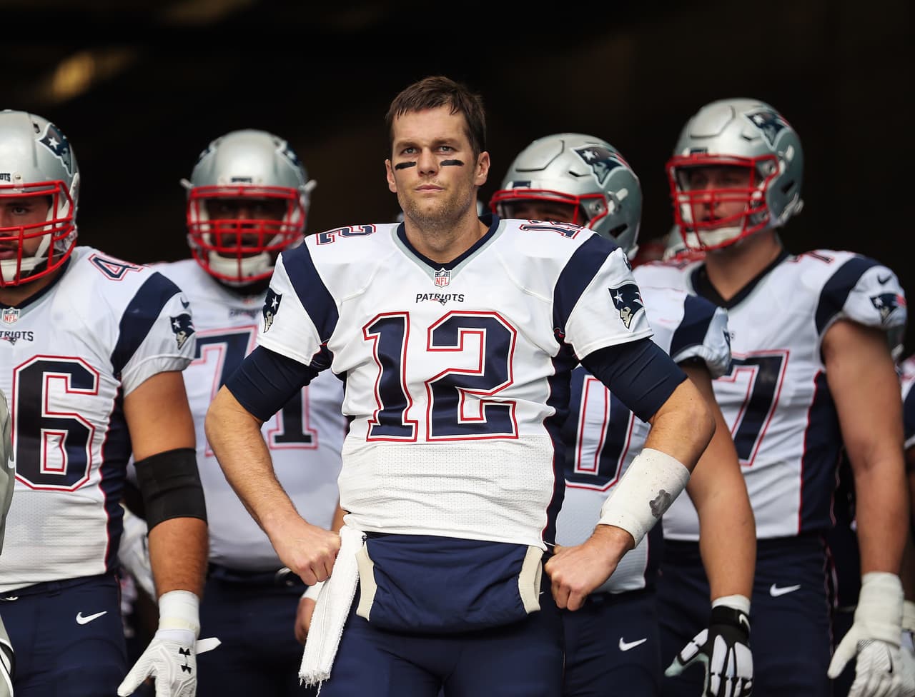 New England Patriots quarterback Tom Brady (12) leads his team to the field before a game against the Miami Dolphins, Sunday, Jan. 1, 2017, in Miami Gardens, Fla. (Tom DiPace via AP)