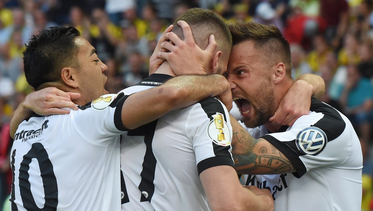Frankfurt's Croatian striker Ante Rebic (C) celebrates with teammates Frankfurt's Mexican midfielder Marco Fabian (L) and Frankfurt's Swiss striker Haris Seferovic after scoring Frankfurt's first goal during the German Cup (DFB Pokal) final football match Eintracht Frankfurt v BVB Borussia Dortmund at the Olympic stadium in Berlin on May 27, 2017. / AFP PHOTO / Christof Stache / RESTRICTIONS: ACCORDING TO DFB RULES IMAGE SEQUENCES TO SIMULATE VIDEO IS NOT ALLOWED DURING MATCH TIME. MOBILE (MMS) USE IS NOT ALLOWED DURING AND FOR FURTHER TWO HOURS AFTER THE MATCH. == RESTRICTED TO EDITORIAL USE == FOR MORE INFORMATION CONTACT DFB DIRECTLY AT +49 69 67880 / (Photo credit should read CHRISTOF STACHE/AFP/Getty Images)