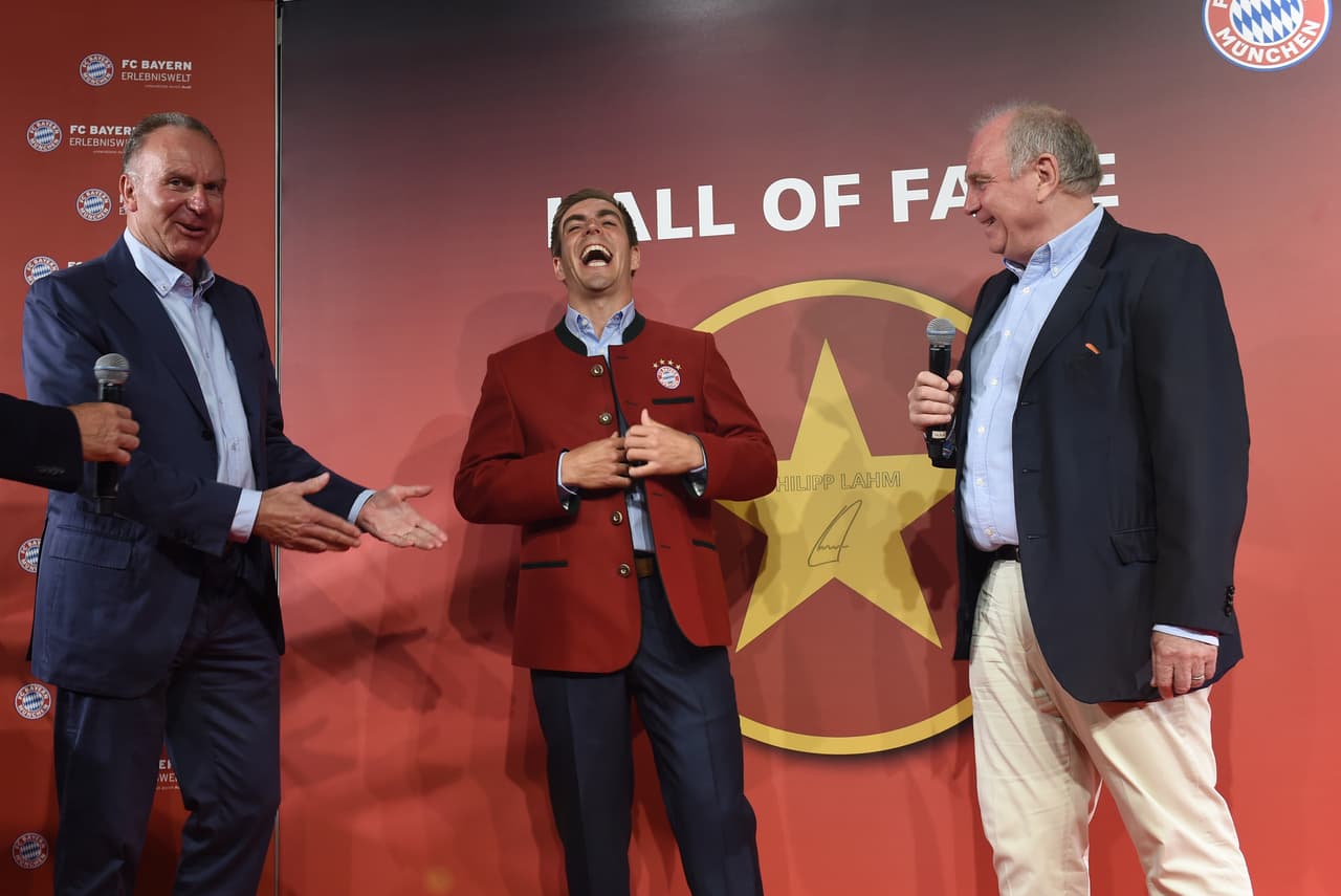 (L-R) The CEO of Bayern Munich Karl-Heinz Rummenigge, Bayern Munich's team leader Philipp Lahm and the President Uli Hoeness joke during the handing over of the so-called legends jacket in the Hall of fame in the museum at the stadium in Munich, southern Germany, on May 29, 2017. The defender of Bayern Munich finished his football career at the end of this season. The stars of the Hall of fame are dedicated to some of the deserved players of the club. / AFP PHOTO / Christof STACHE (Photo credit should read CHRISTOF STACHE/AFP/Getty Images)