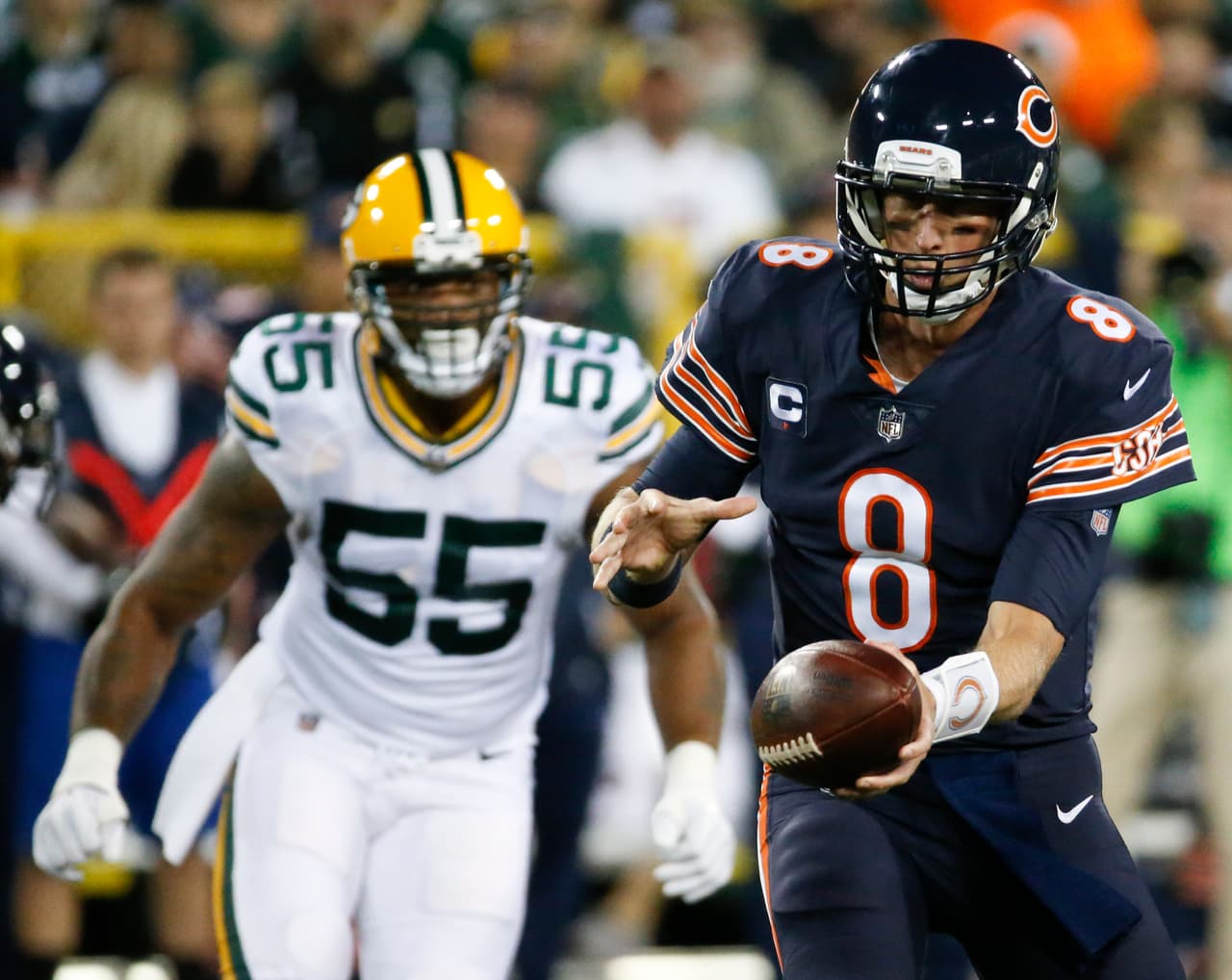 Chicago Bears' Mike Glennon hands off in front of Green Bay Packers' Ahmad Brooks during the first half of an NFL football game Thursday, Sept. 28, 2017, in Green Bay, Wis. (AP Photo/Mike Roemer)