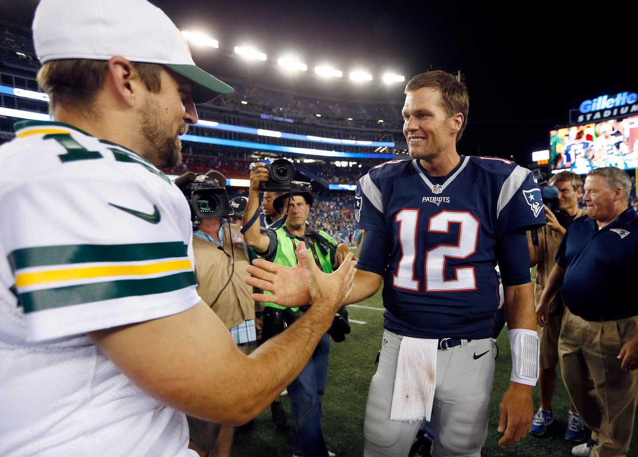 Green Bay Packers quarterback Aaron Rodgers, left, and New England Patriots quarterback Tom Brady, right, meet on the field after an NFL preseason football game Thursday, Aug. 13, 2015, in Foxborough, Mass. The Packers won 22-11. (AP Photo/Michael Dwyer)
