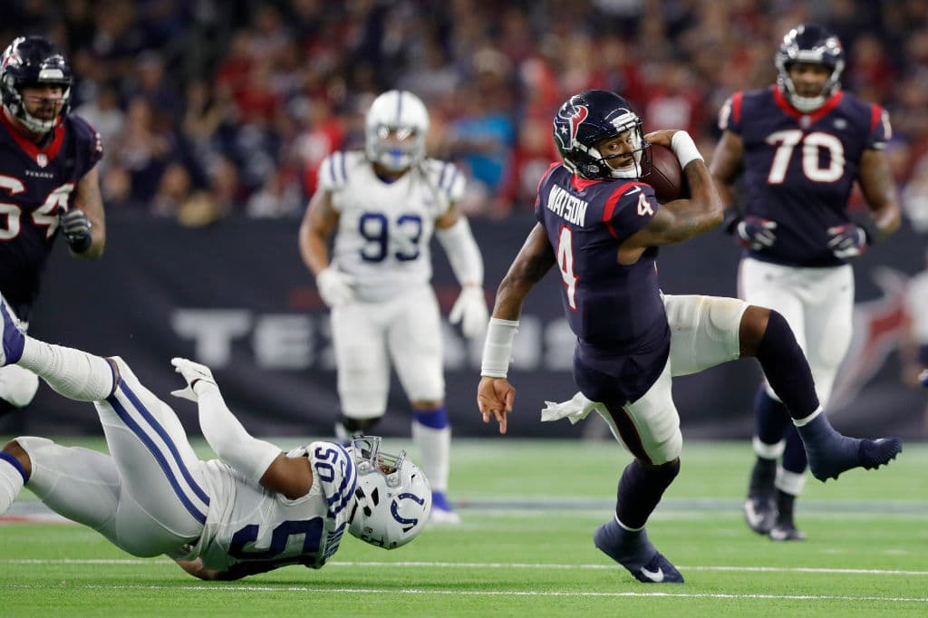 HOUSTON, TX - JANUARY 05: Deshaun Watson #4 of the Houston Texans is tripped up by Anthony Walker #50 of the Indianapolis Colts in the third quarter during the Wild Card Round at NRG Stadium on January 5, 2019 in Houston, Texas. (Photo by Tim Warner/Getty Images)