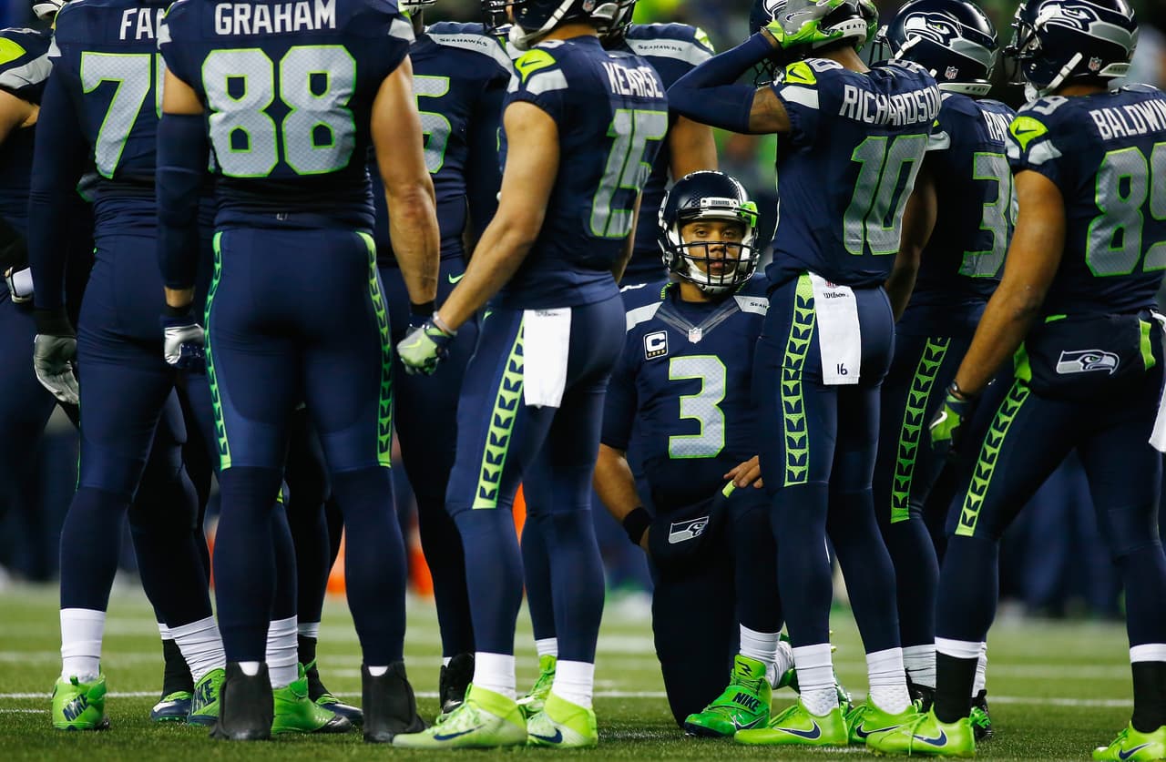 SEATTLE, WA - JANUARY 07: Russell Wilson #3 of the Seattle Seahawks huddles with teammates during the first half against the Detroit Lions in the NFC Wild Card game at CenturyLink Field on January 7, 2017 in Seattle, Washington. (Photo by Jonathan Ferrey/Getty Images)