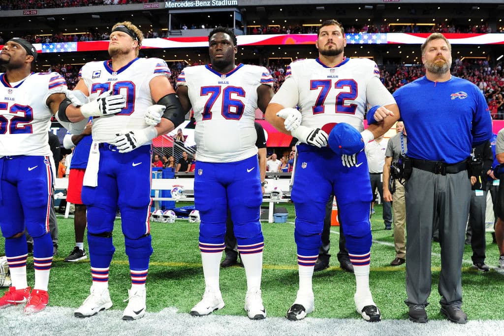 ATLANTA, GA - OCTOBER 01: Buffalo Bills players lock arms during the national anthem prior to the game against the Atlanta Falcons at Mercedes-Benz Stadium on October 1, 2017 in Atlanta, Georgia. (Photo by Scott Cunningham/Getty Images)