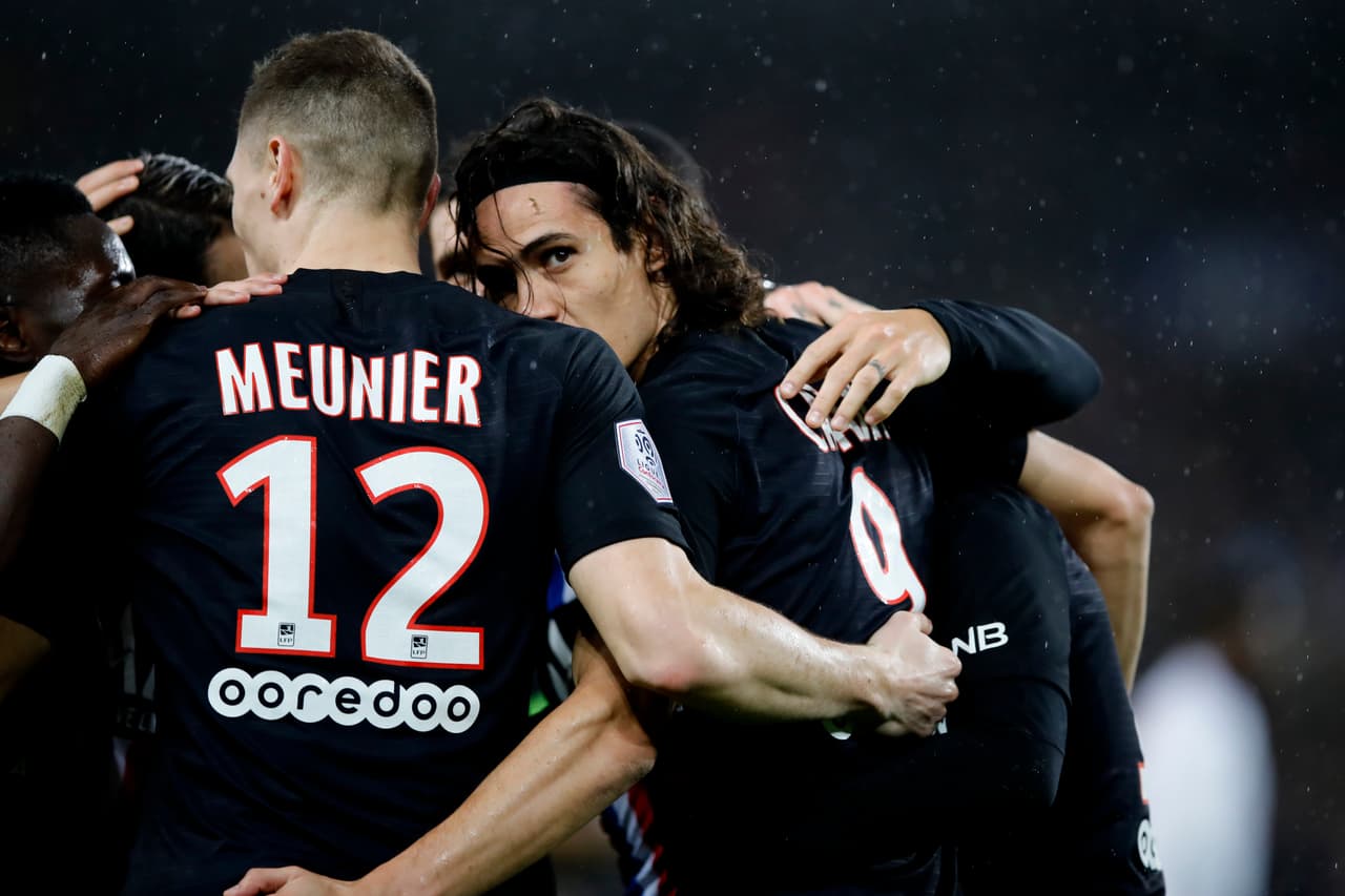 PSG's Edinson Cavani, right, celebrates with his teammates his goal against Montpellier during the French League One soccer match between Paris-Saint-Germain and Montpellier at the Parc des Princes stadium in Paris, Saturday Feb. 1, 2020. (AP Photo/Christophe Ena)