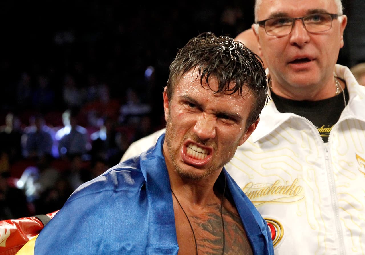 LAS VEGAS, NV - NOVEMBER 07: WBO featherweight champion Vasyl Lomachenko (C) makes a face after defeating Romulo Koasicha in their title fight at the Thomas & Mack Center on November 7, 2015 in Las Vegas, Nevada. Lomachenko defended his title with a 10th-round KO. (Photo by Steve Marcus/Getty Images)
