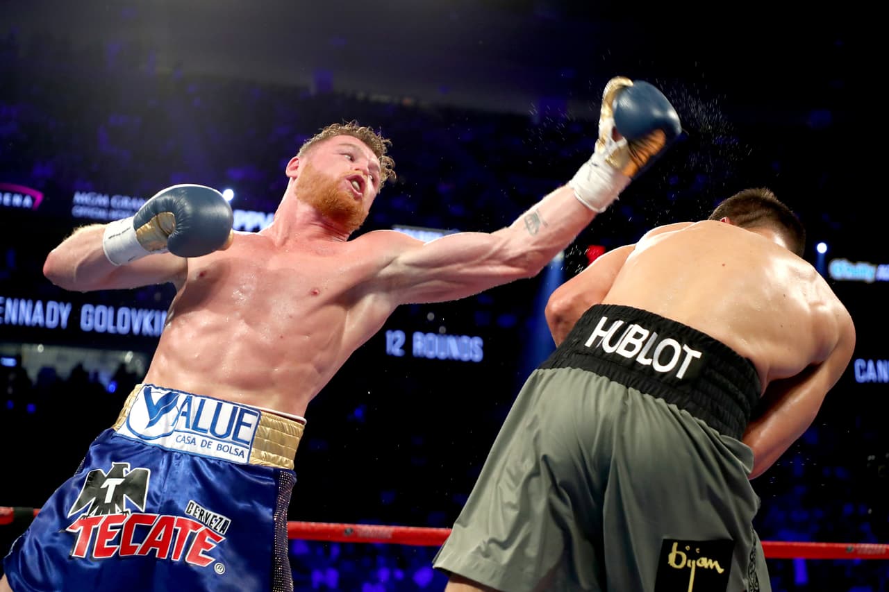 LAS VEGAS, NV - SEPTEMBER 16: (L-R) Canelo Alvarez throws a punch at Gennady Golovkin during their WBC, WBA and IBF middleweight championionship bout at T-Mobile Arena on September 16, 2017 in Las Vegas, Nevada. (Photo by Al Bello/Getty Images)