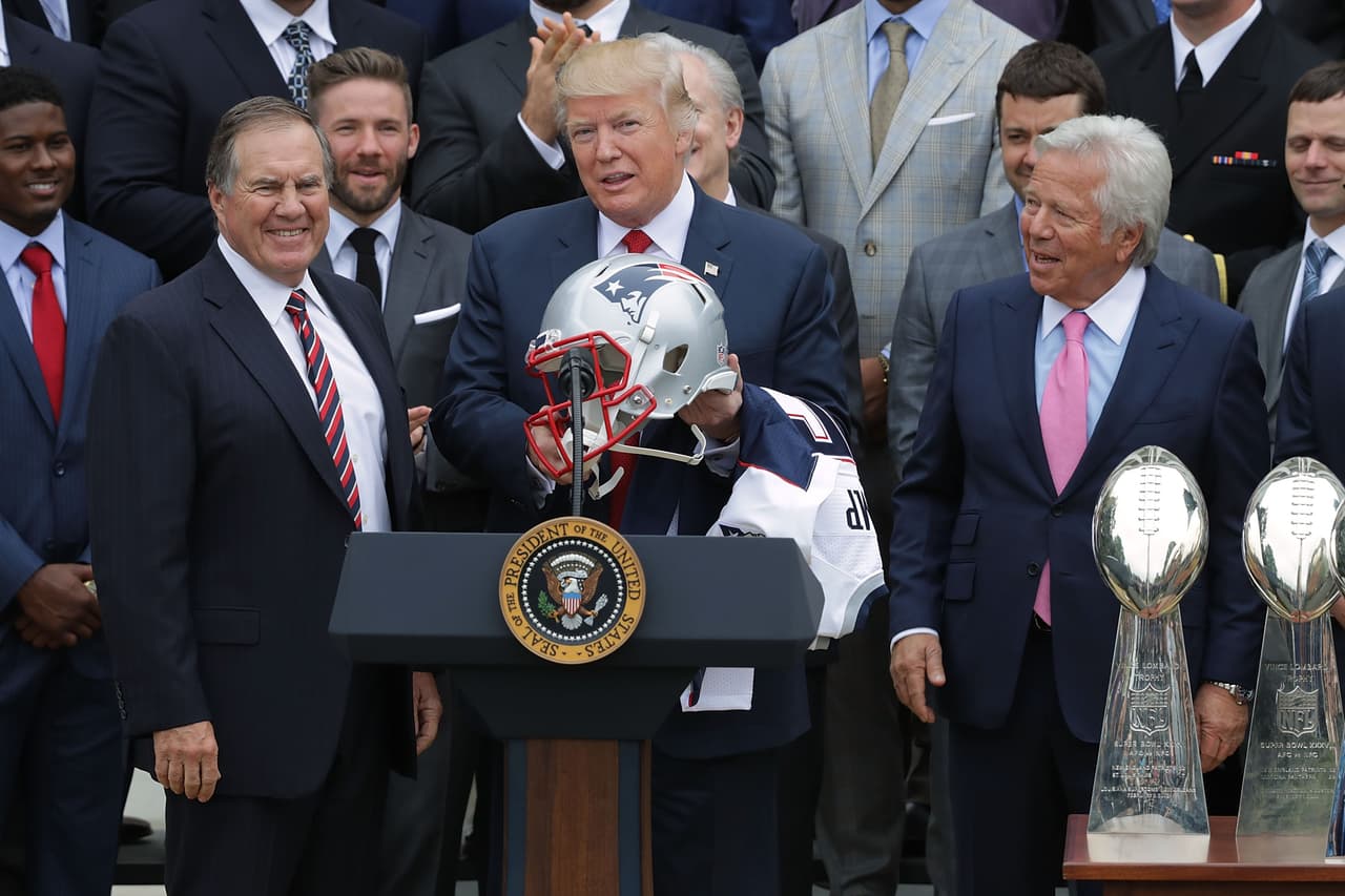 WASHINGTON, DC - APRIL 19: New England Patriots Head Coach Bill Belichick (L) and team owner Robert Kraft (R) present a football helmet to U.S. President Donald Trump during a celebration of the team's Super Bowl victory on the South Lawn at the White House April 19, 2017 in Washington, DC. It was the team's fifth Super Bowl victory since 1960. (Photo by Chip Somodevilla/Getty Images)