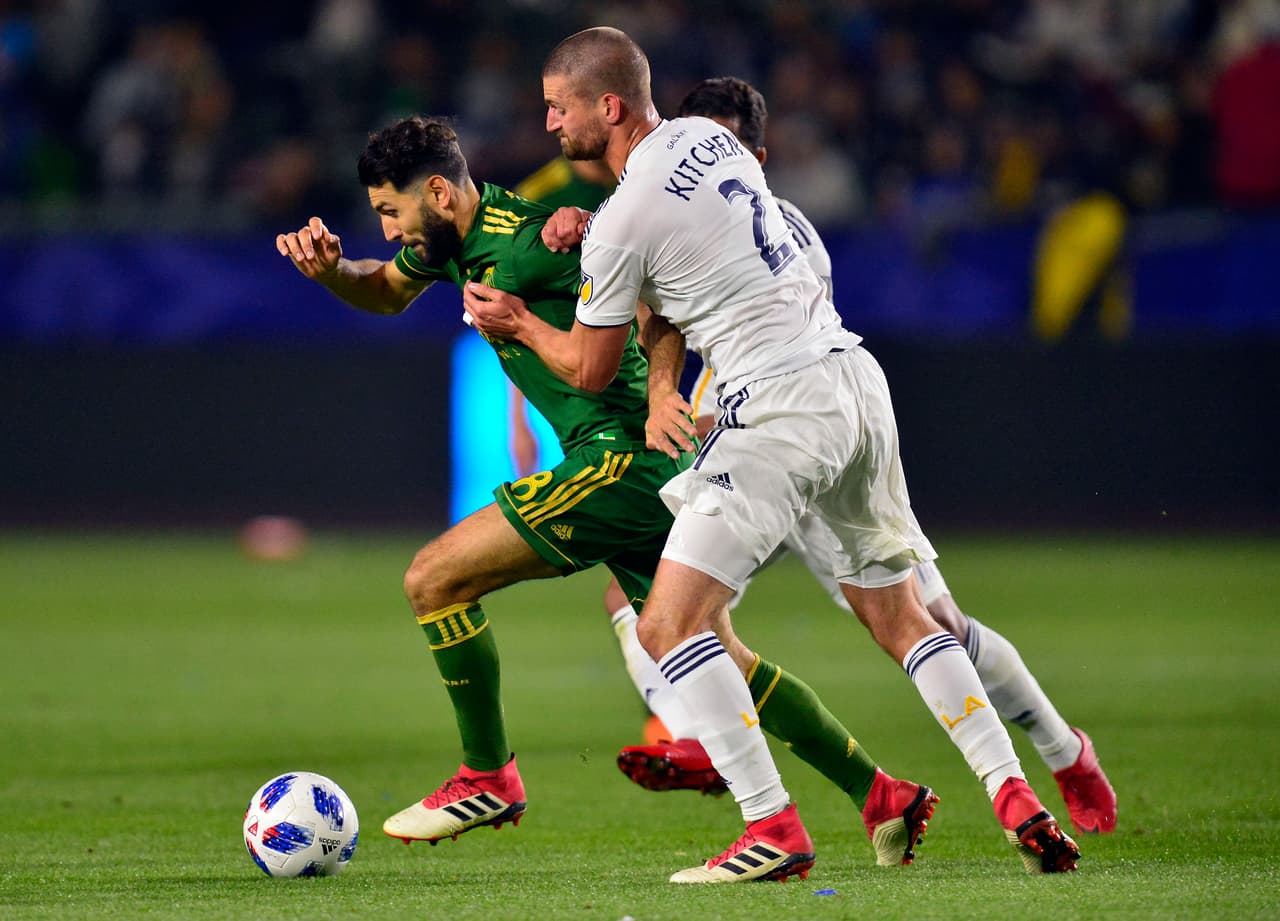 Mar 4, 2018; Carson, CA, USA; Portland Timbers midfielder Diego Valeri (8) moves the ball against Los Angeles Galaxy defender Perry Kitchen (2) during the first half at StubHub Center. Mandatory Credit: Gary A. Vasquez-USA TODAY Sports