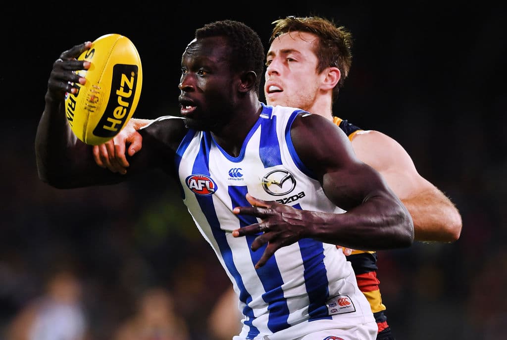 ADELAIDE, AUSTRALIA - AUGUST 19: Majak Daw of the Kangaroos competes with Richard Douglas of the Adelaide Crows during the round 22 AFL match between the Adelaide Crows and North Melbourne Kangaroos at Adelaide Oval on August 19, 2018 in Adelaide, Australia. (Photo by Mark Brake/Getty Images)
