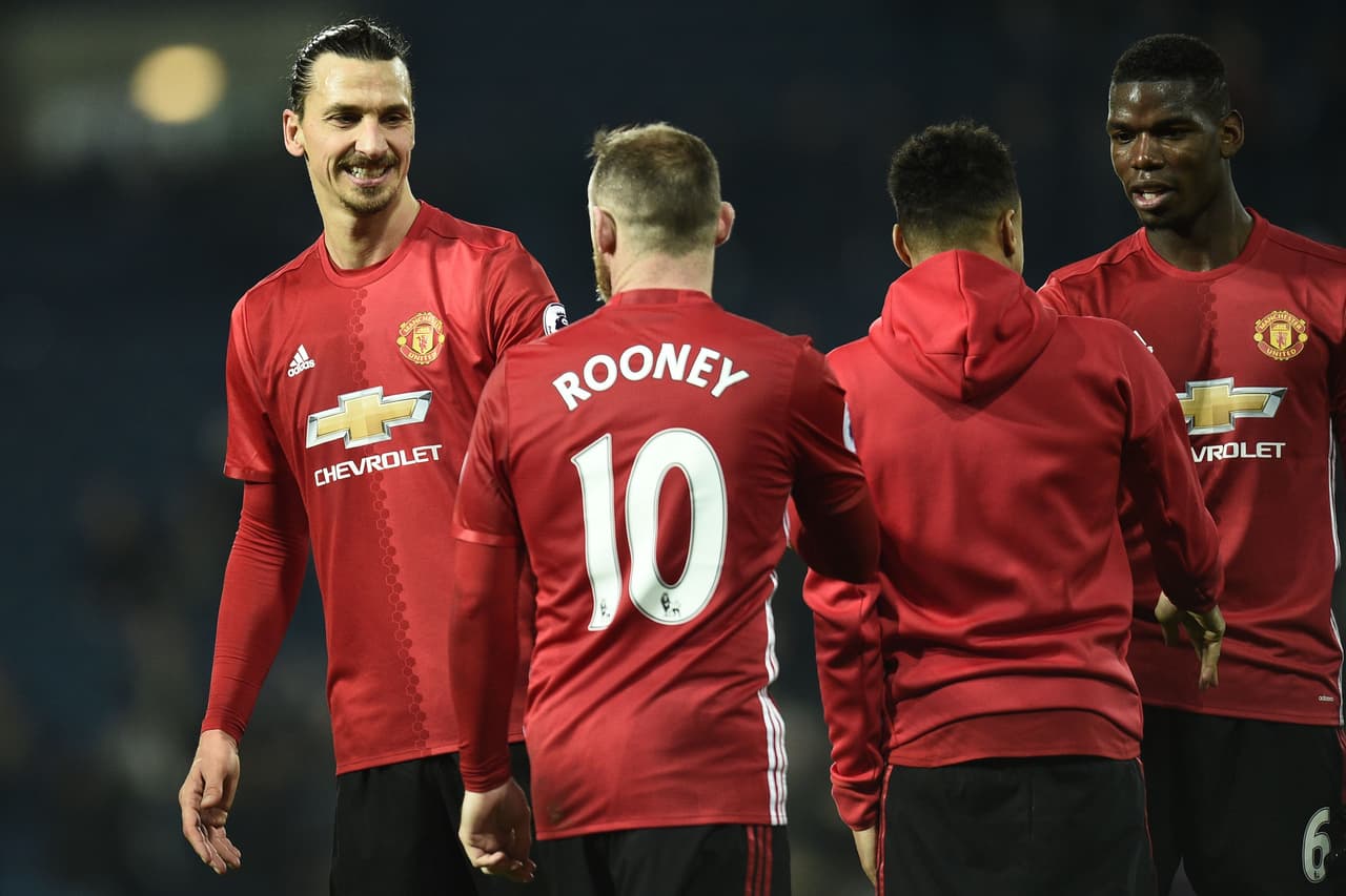 Manchester United's Swedish striker Zlatan Ibrahimovic (L), Manchester United's English striker Wayne Rooney (2nd L), Manchester United's English midfielder Jesse Lingard and Manchester United's French midfielder Paul Pogba (R) celebrate on the pitch after the English Premier League football match between West Bromwich Albion and Manchester United at The Hawthorns stadium in West Bromwich, central England, on December 17, 2016. Manchester United won the game 2-0. / AFP / Oli SCARFF / RESTRICTED TO EDITORIAL USE. No use with unauthorized audio, video, data, fixture lists, club/league logos or 'live' services. Online in-match use limited to 75 images, no video emulation. No use in betting, games or single club/league/player publications. / (Photo credit should read OLI SCARFF/AFP/Getty Images)