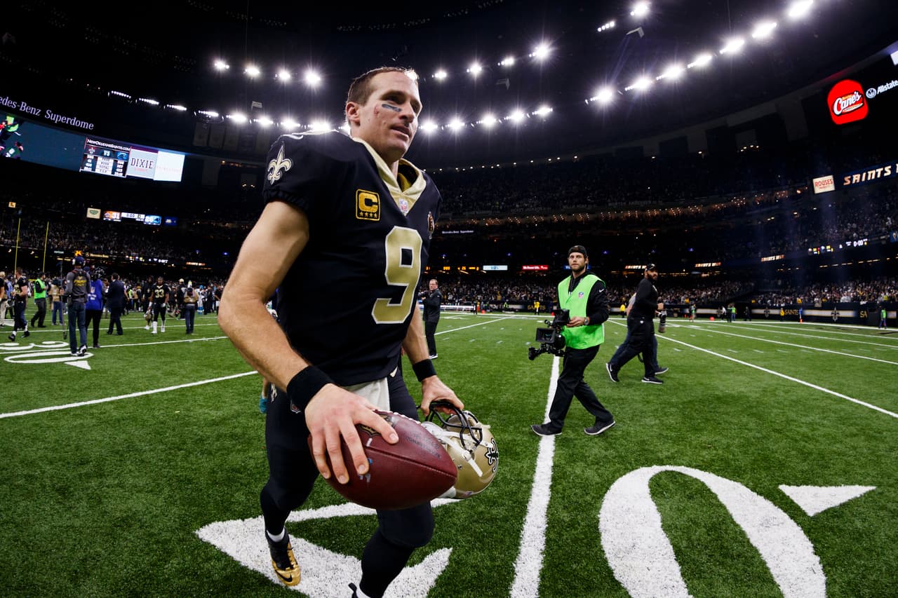 New Orleans Saints quarterback Drew Brees (9) runs off the field after an NFL football NFC wild card playoff game against the Carolina Panthers, Sunday, Jan. 7, 2018, in New Orleans. The Saints defeated the Panthers, 31-26. (Ryan Kang via AP)