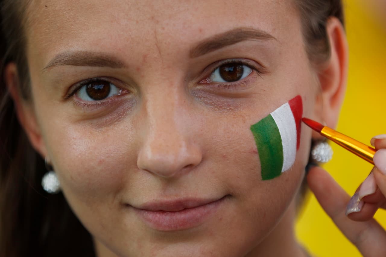 A spectator is coloring her face in a Mexico's flag colors ahead of the group F match between Mexico and Sweden, at the 2018 soccer World Cup in the Yekaterinburg Arena in Yekaterinburg , Russia, Wednesday, June 27, 2018. (AP Photo/Eduardo Verdugo)
