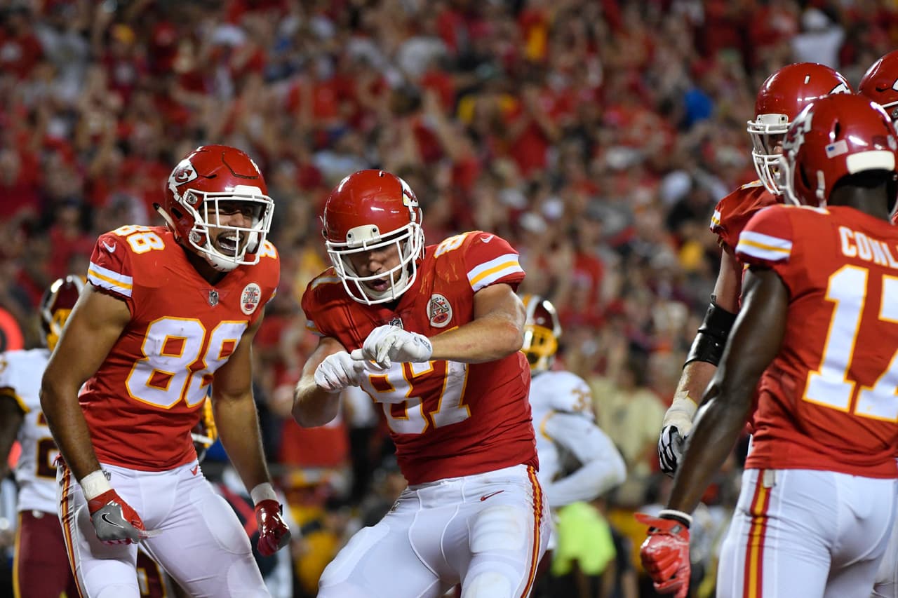 Kansas City Chiefs tight end Travis Kelce (87) celebrates his touchdown in front of teammate tight end Ross Travis (88) during the first half of an NFL football game against the Washington Redskins in Kansas City, Mo., Monday, Oct. 2, 2017. (AP Photo/Ed Zurga)