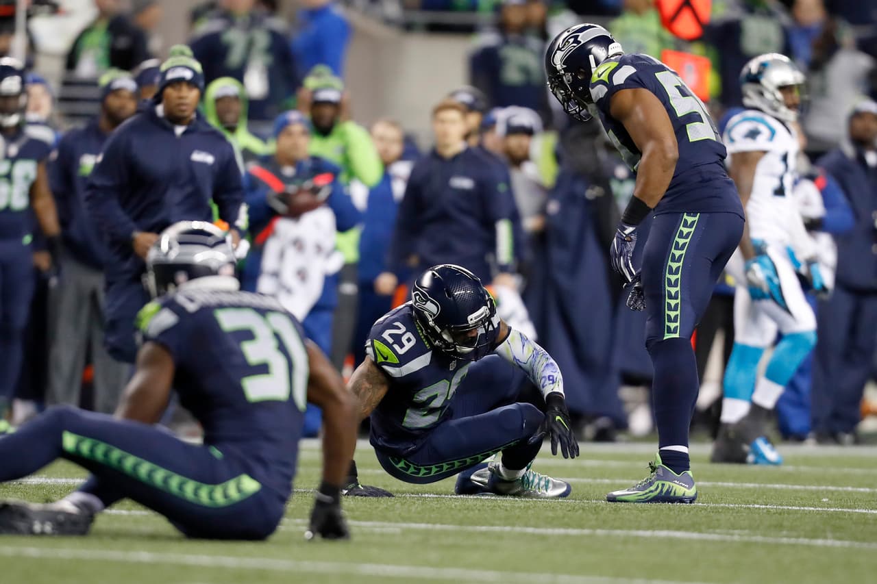 Seattle Seahawks free safety Earl Thomas (29) is slow to get up after a collision with strong safety Kam Chancellor (31) during an NFL football game against the Carolina Panthers, Sunday, Dec. 4, 2016, in Seattle. The Seahawks defeated the Panthers, 40-7. (Ryan Kang via AP)