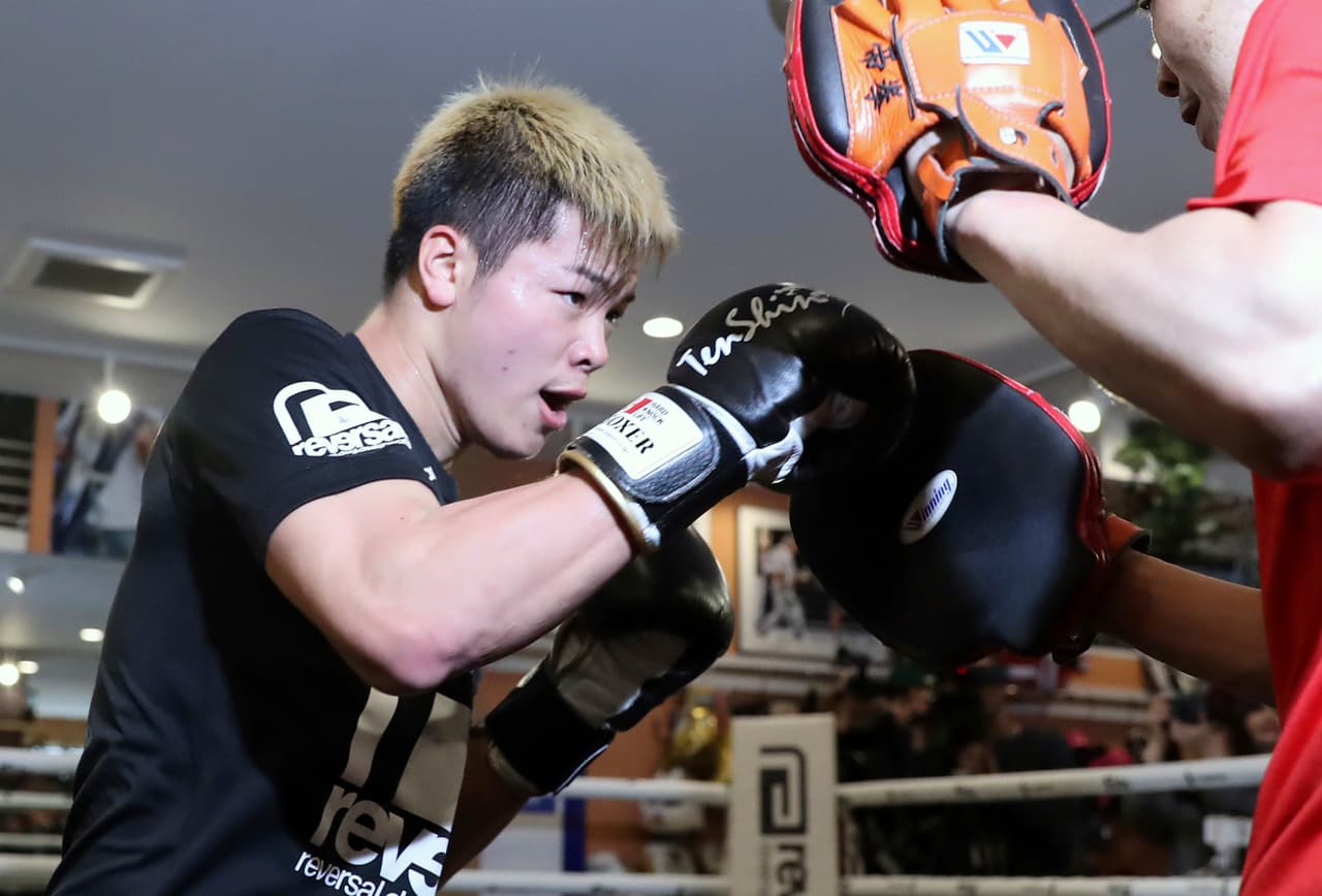 Japanese kickboxer Tenshin Nasukawa warms up at his gym in Matsudo, northwest of Tokyo Tuesday, Dec. 18, 2018. Nasukawa is scheduled to face Floyd Mayweather Jr. in a three-round exhibition boxing bout in Japan on New Year's Eve. (AP Photo/Eugene Hoshiko)