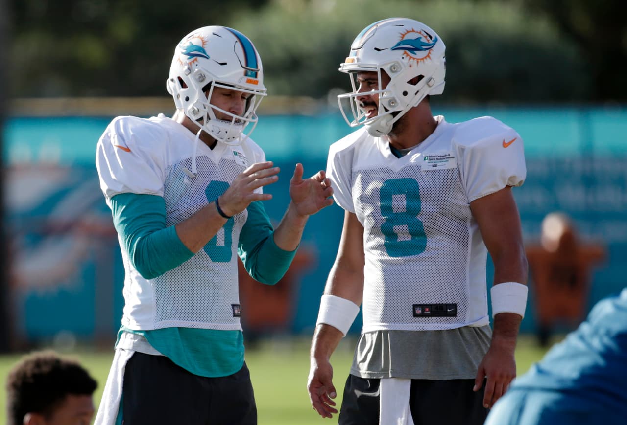 Miami Dolphins quarterback Jay Cutler (6) talks with quarterback Matt Moore (8) during an NFL football training camp, Tuesday, Aug. 8, 2017, in Davie, Fla. (AP Photo/Lynne Sladky)