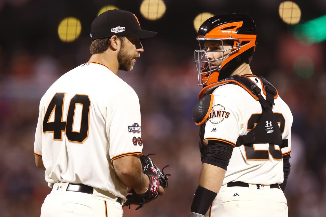 SAN FRANCISCO, CA - OCTOBER 10: Madison Bumgarner #40 of the San Francisco Giants speaks with Buster Posey #28 during Game Three of their National League Division Series against the Chicago Cubs at AT&T Park on October 10, 2016 in San Francisco, California. (Photo by Ezra Shaw/Getty Images)