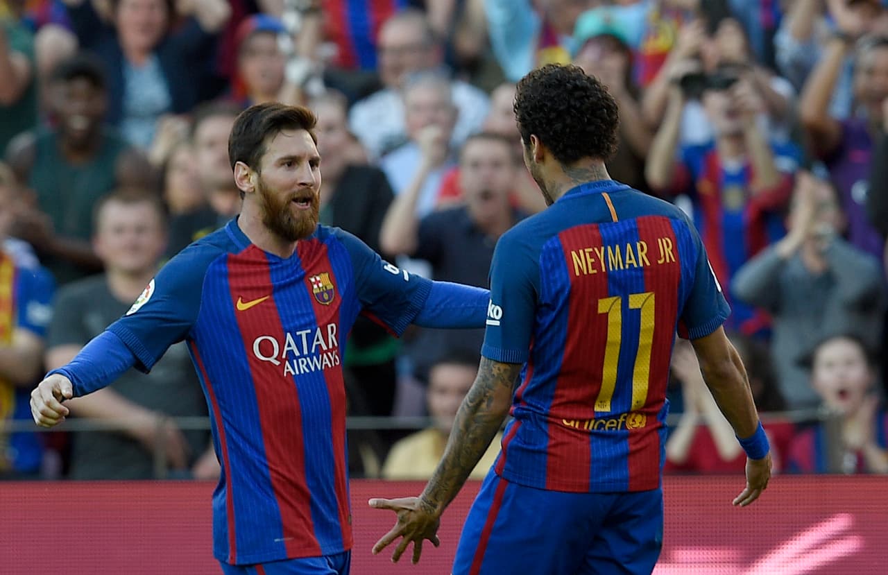 Barcelona's Argentinian forward Lionel Messi (L) celebrates with Barcelona's Brazilian forward Neymar after scoring a goal during the Spanish league football match FC Barcelona vs Villarreal CF at the Camp Nou stadium in Barcelona on May 6, 2017. / AFP PHOTO / LLUIS GENE (Photo credit should read LLUIS GENE/AFP/Getty Images)
