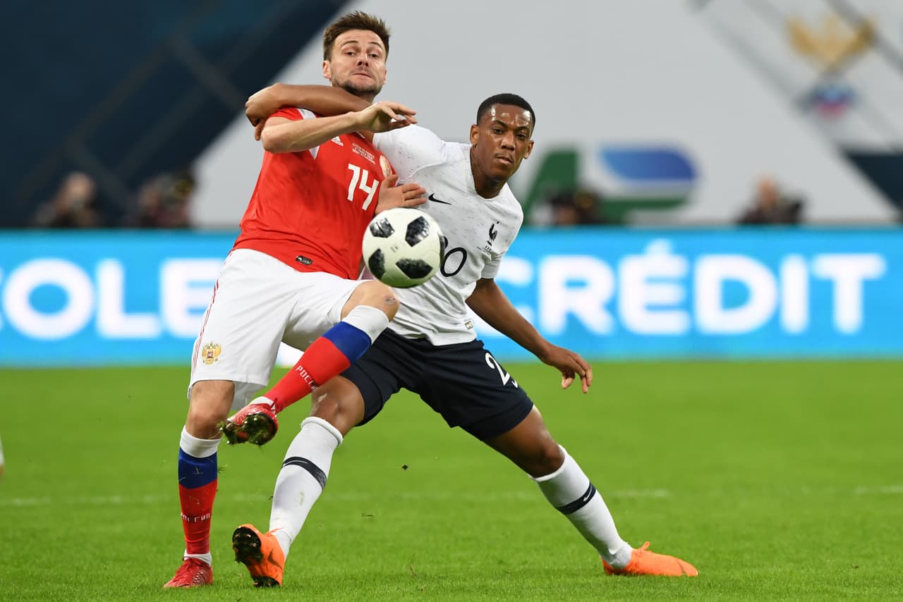 Russia's defender Vladimir Granat and France's forward Anthony Martial vie for the ball during an international friendly football match between Russia and France at the Saint Petersburg Stadium in Saint Petersburg on March 27, 2018. / AFP PHOTO / Kirill KUDRYAVTSEV (Photo credit should read KIRILL KUDRYAVTSEV/AFP/Getty Images)