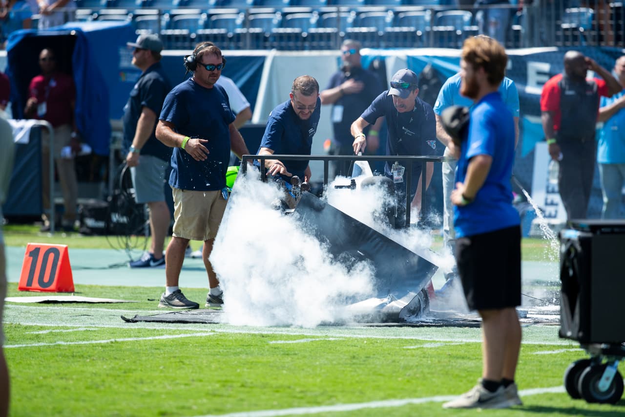 NASHVILLE, TN - SEPTEMBER 15: Tennessee Titans field crews extinguish a fire from a failed pyrotechnic device before the game against the Indianapolis Colts at Nissan Stadium on September 15, 2019 in Nashville, Tennessee. (Photo by Brett Carlsen/Getty Images)