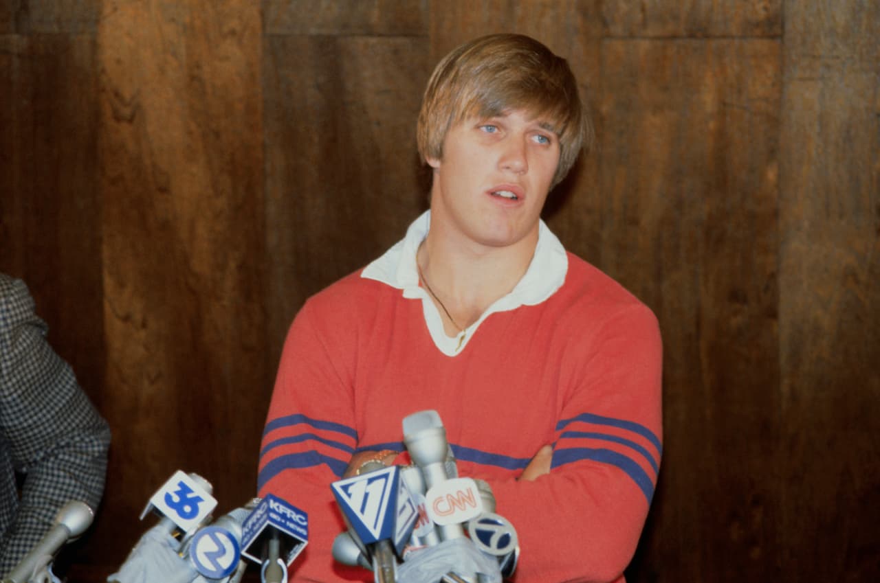 (Original Caption) San Jose, California: John Elway (R), Stanford's All-American quarterback and the first player picked in the National Football League draft, announced, April 28th, he has "agreed in principle" to a 5-year contract with the Denver Broncos. Elway and his father Jack (L), who is head football coach at San Jose State, shown as they tell press they were thoroughly frustrated by how the NFL draft works, and they were especially disappointed in the Baltimore Colts.
